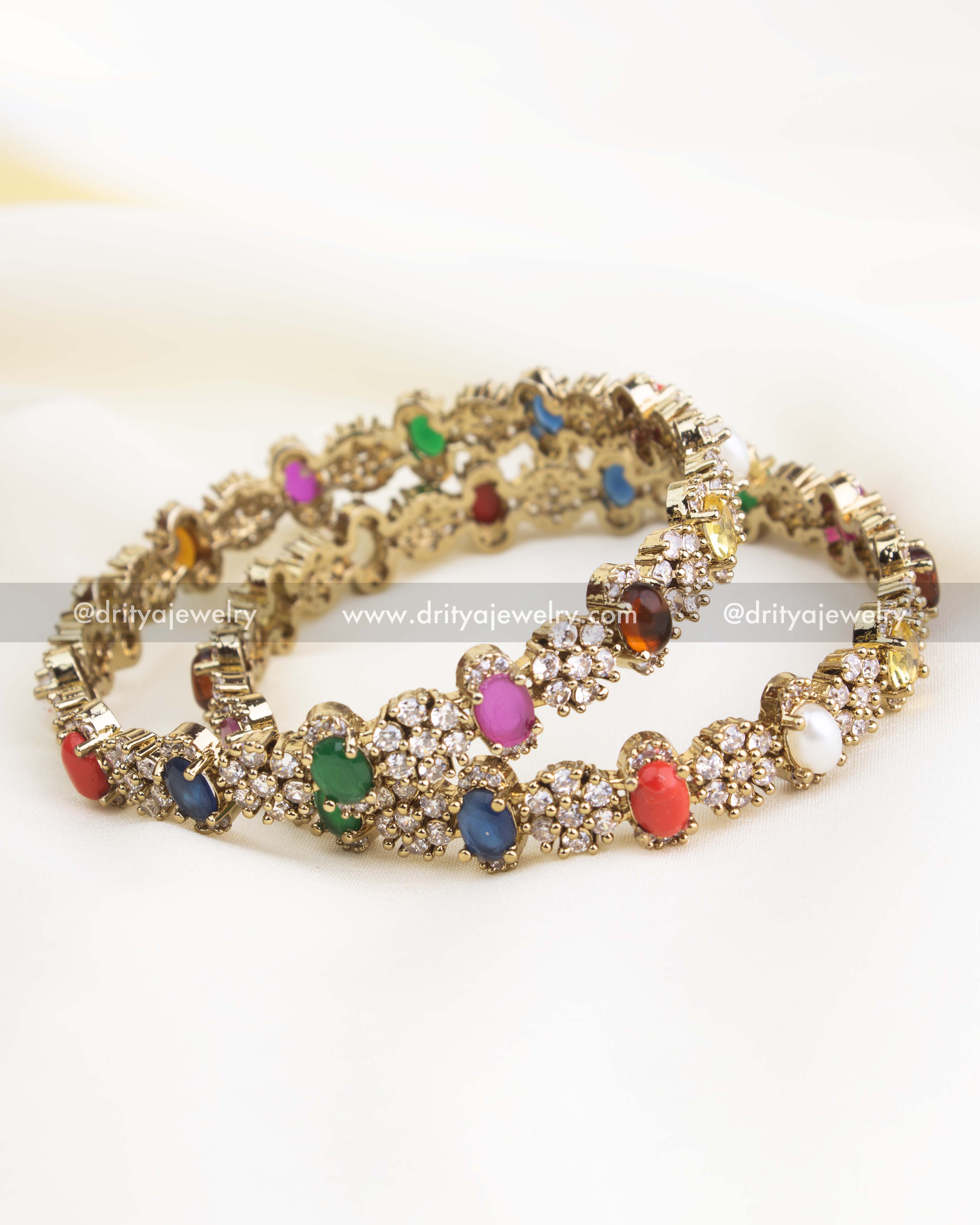 Victorian gold bangles featuring multicolor Navaratna stones and CZ clusters.