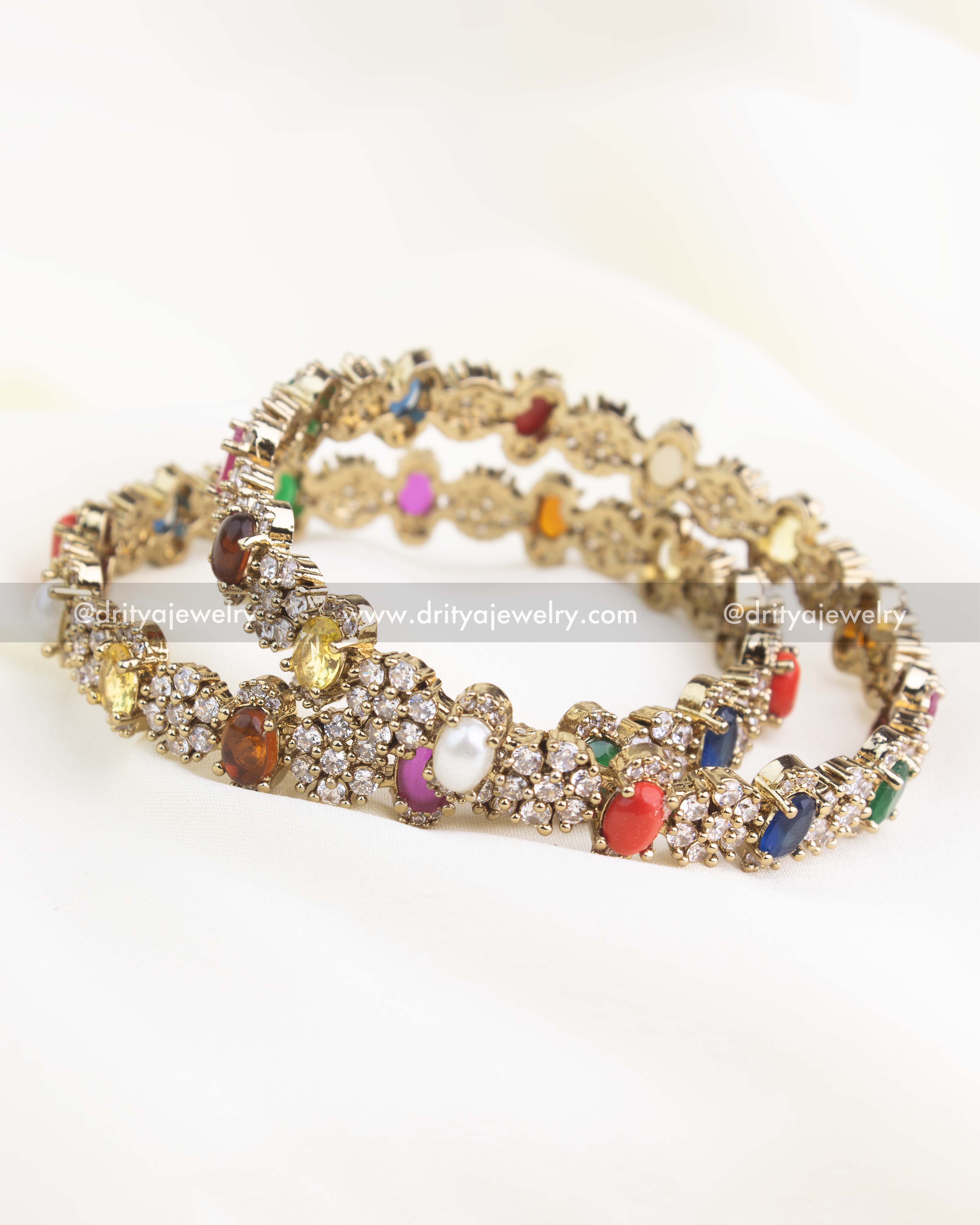 Victorian gold bangles featuring multicolor Navaratna stones and CZ clusters.