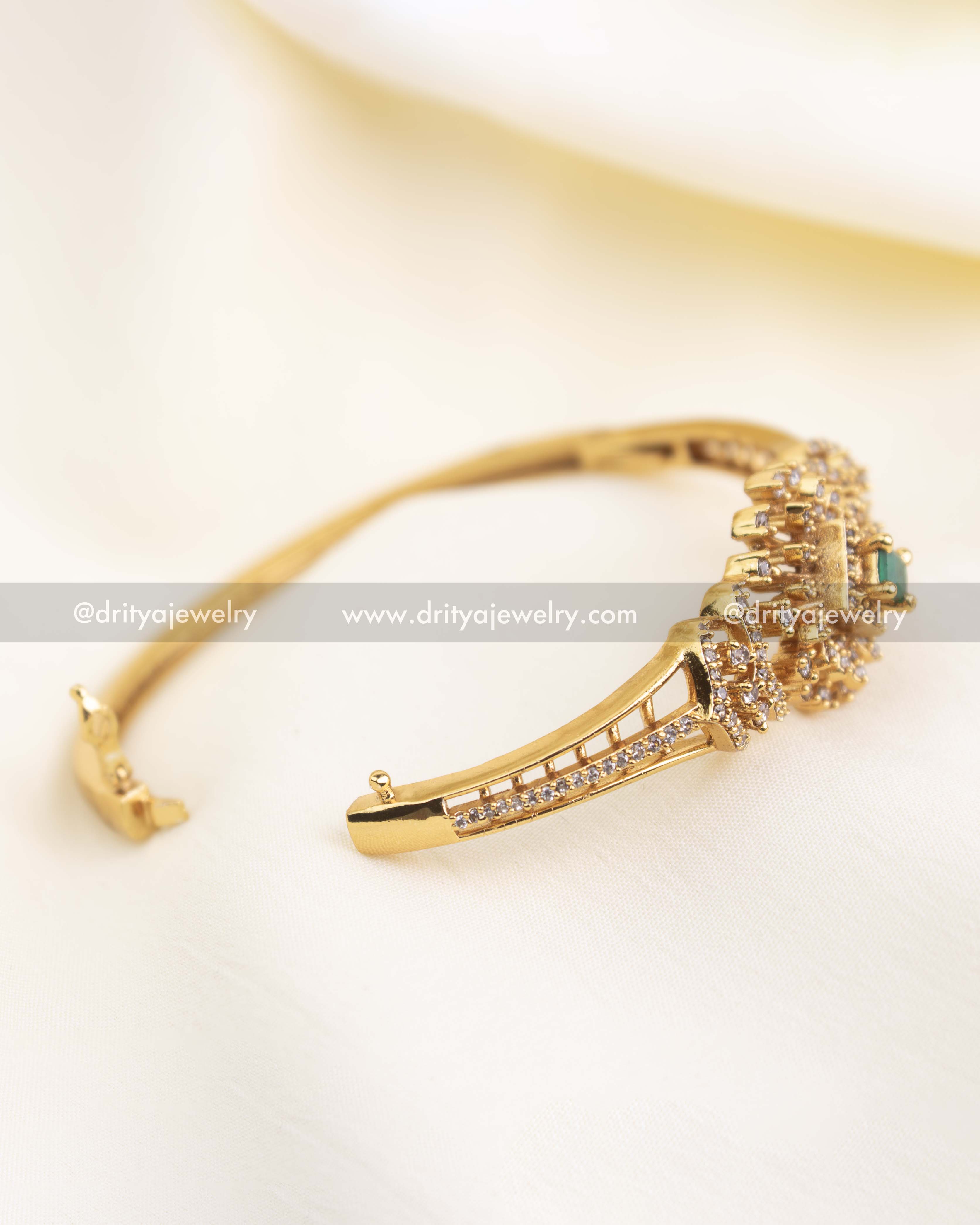 Side-open CZ kada showing clasp mechanism and CZ-lined band detailing.