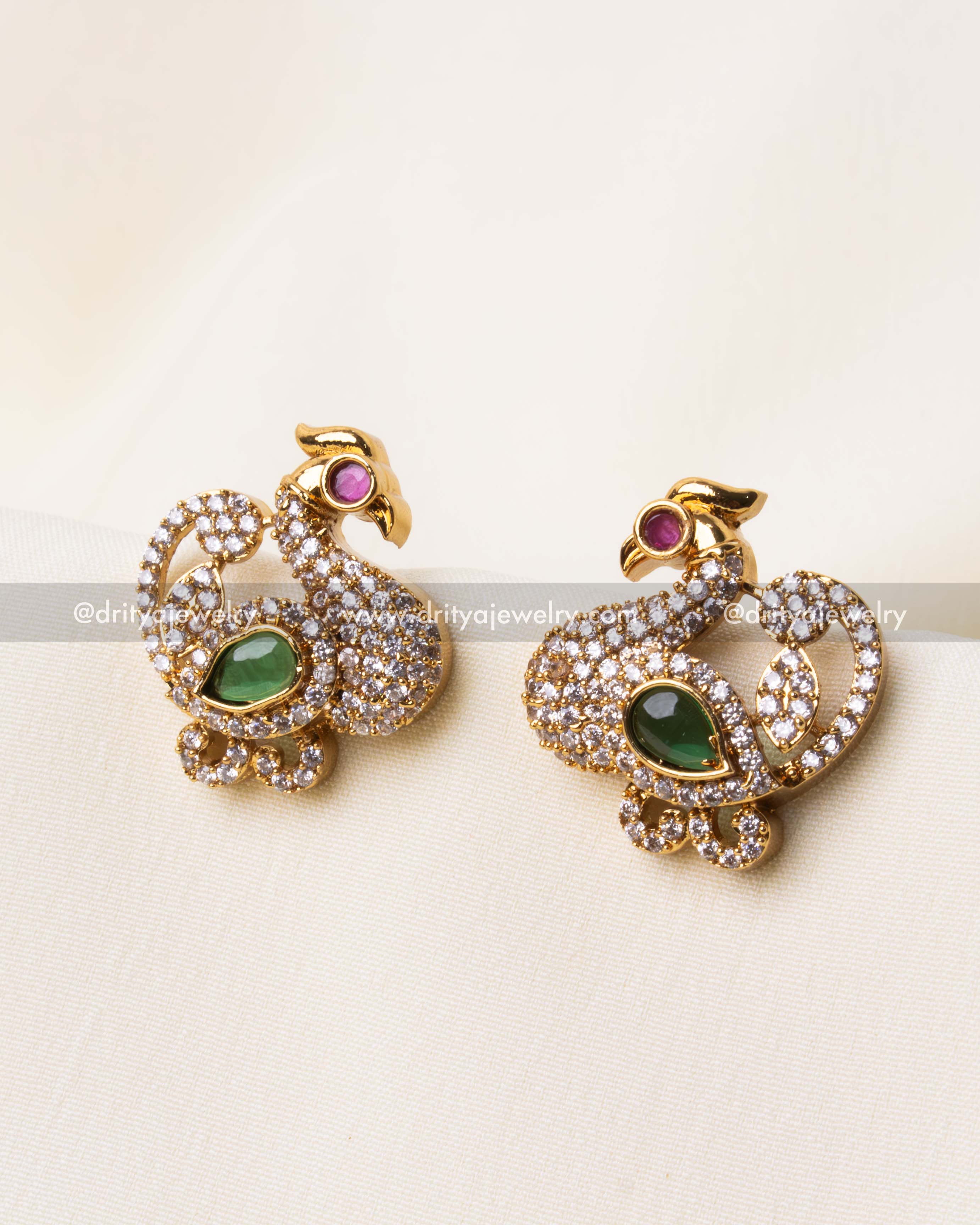 Gold-plated peacock earrings with dazzling AD stones and a rich green gemstone accent.