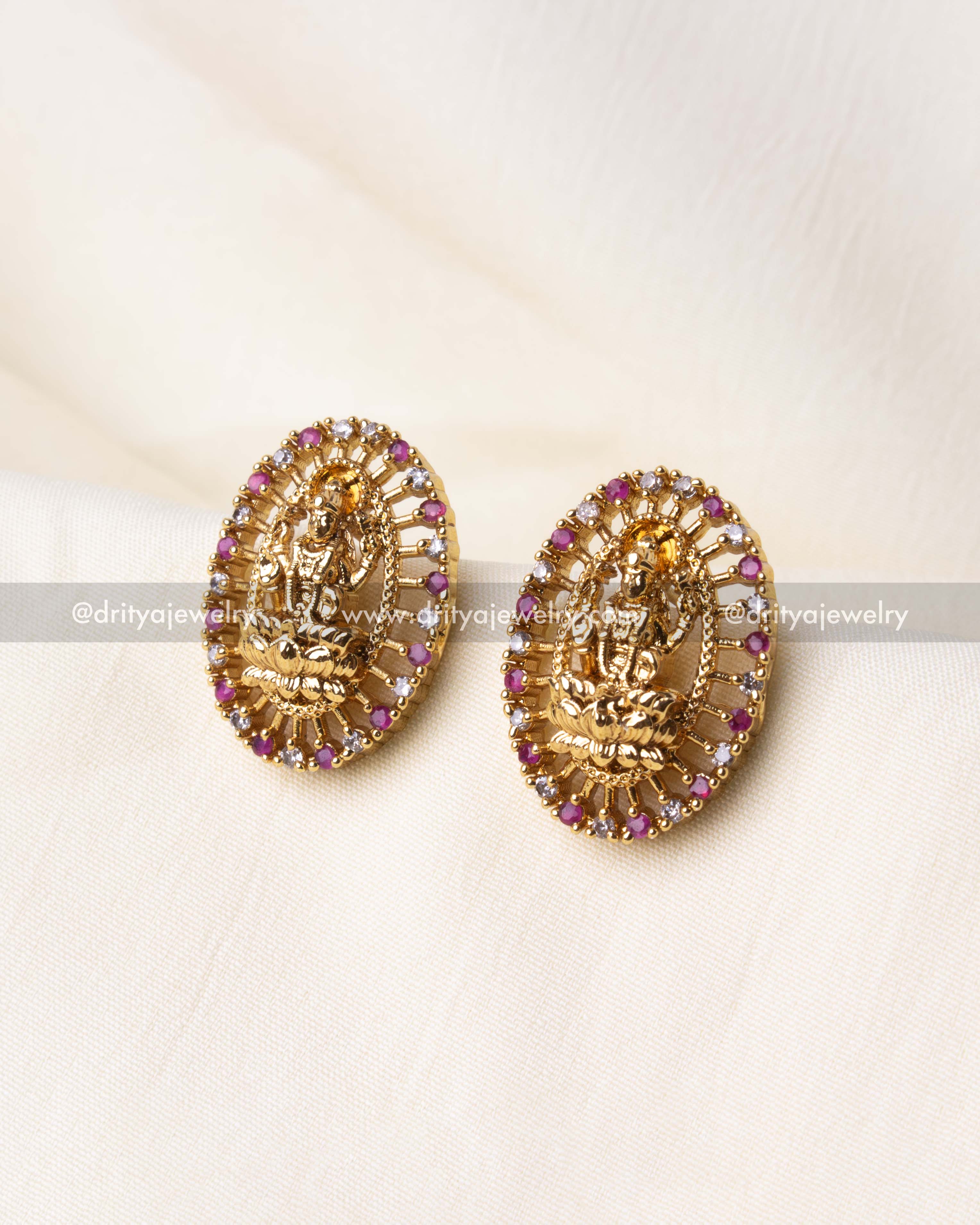 Elegant gold-plated Nakshi stud earrings with pink CZ stones and intricate Lakshmi Devi motif.