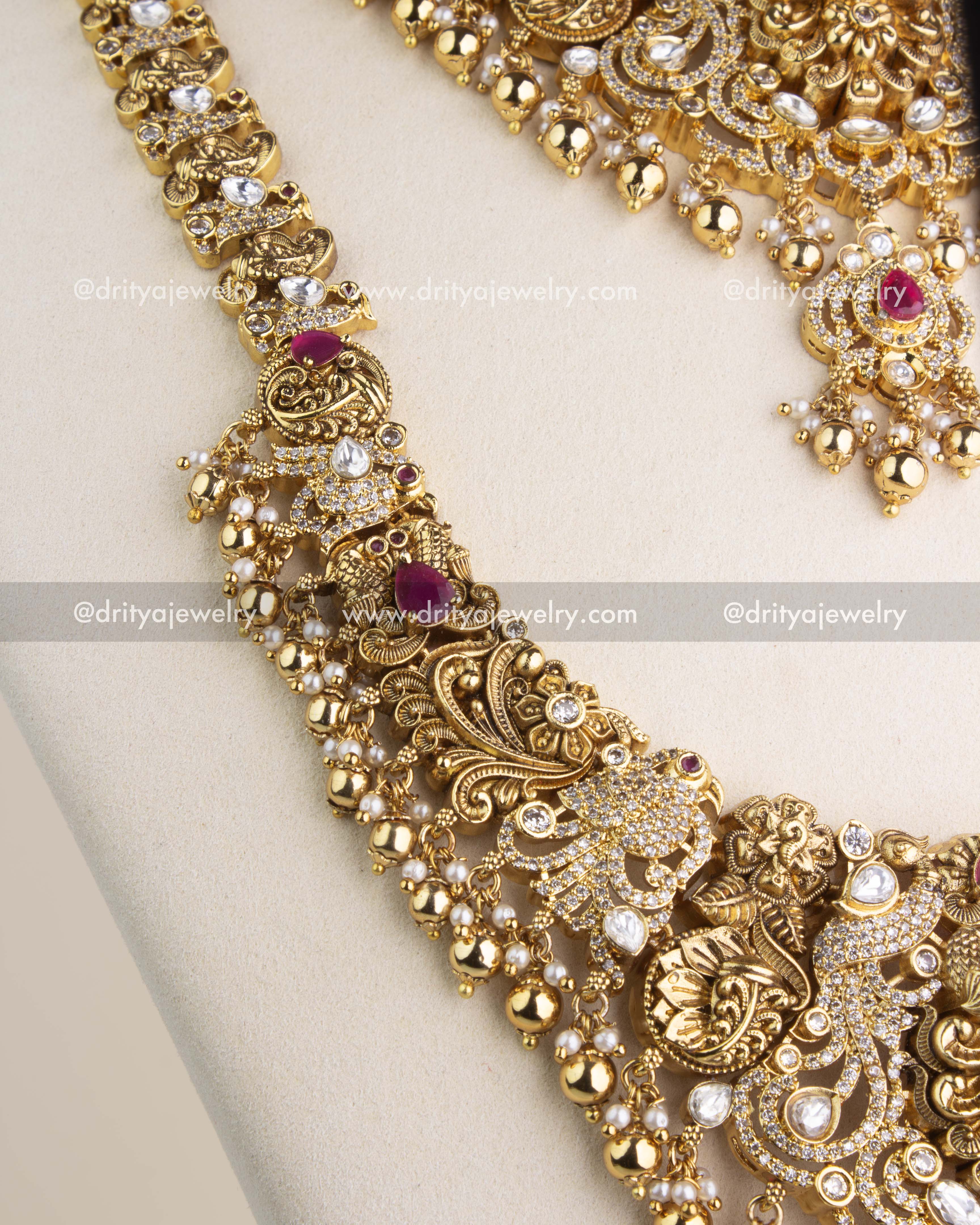 Close-up of the necklace chain showcasing intricate kundan settings, ruby-red embellishments, and heritage-inspired motifs.