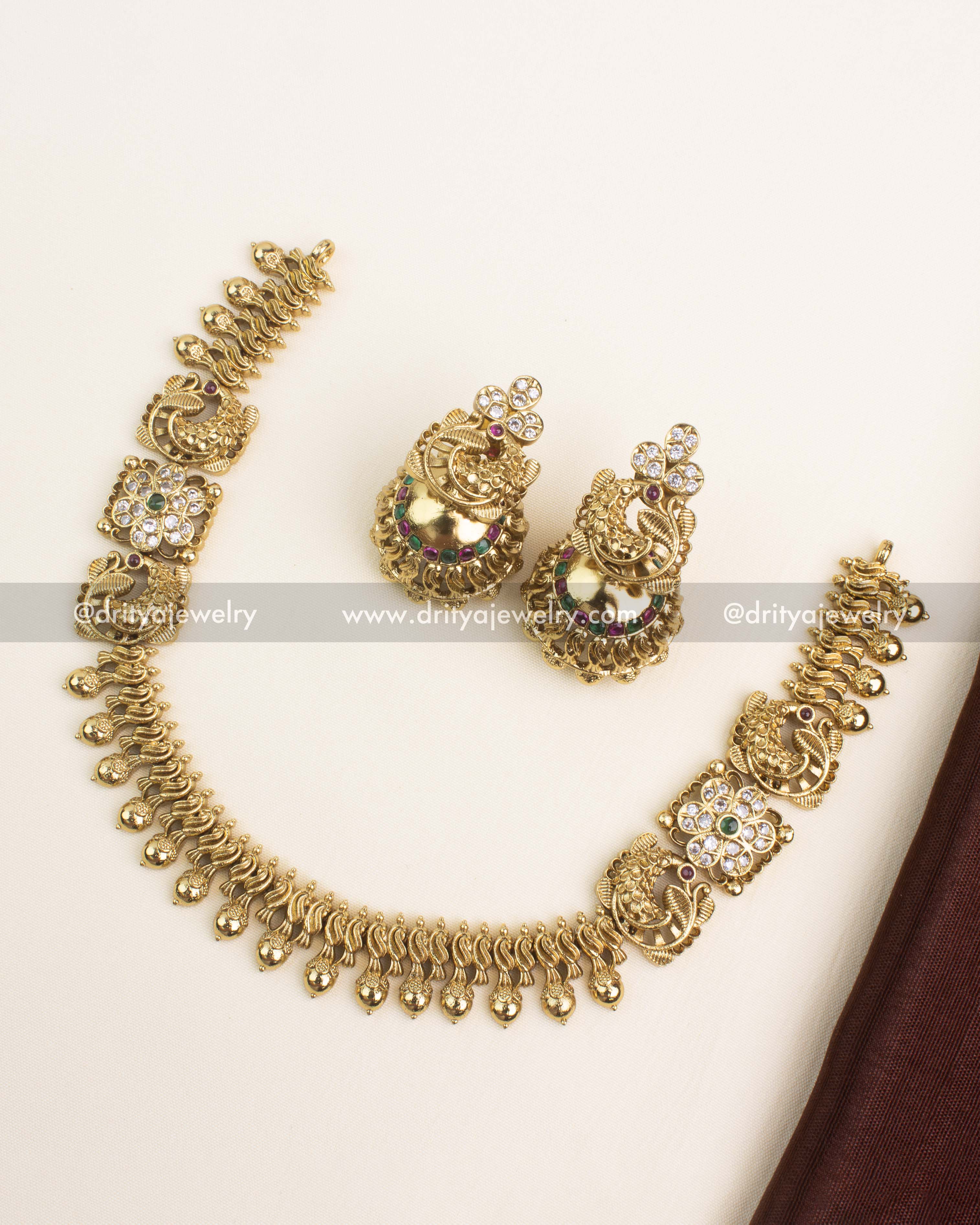 Antique short necklace set with peacock motif, ruby and emerald stone accents, and intricate droplet detailing.