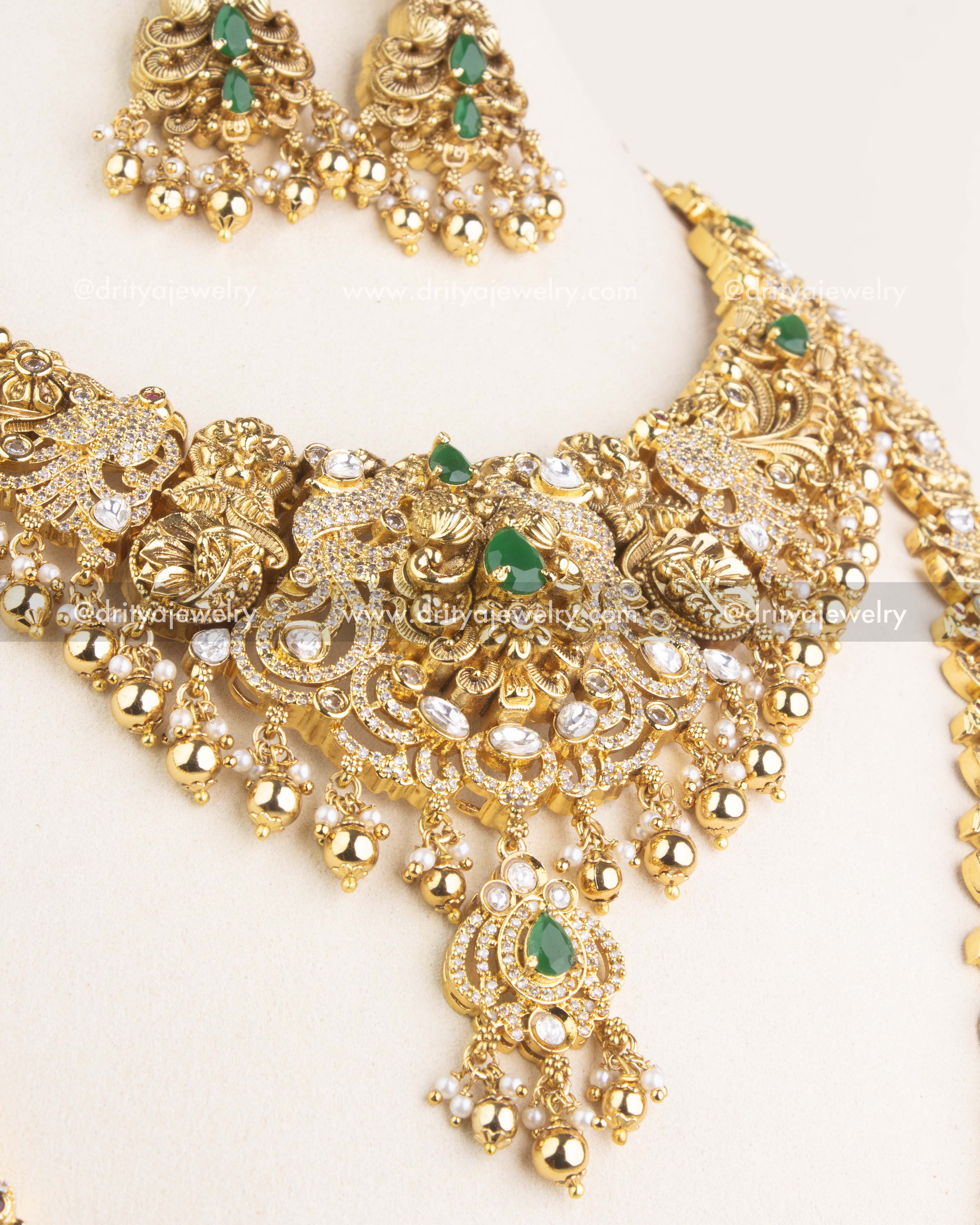 Close-up view of the premium antique short necklace showcasing detailed polki kundan work, green stone centerpiece, and hanging gold beads.