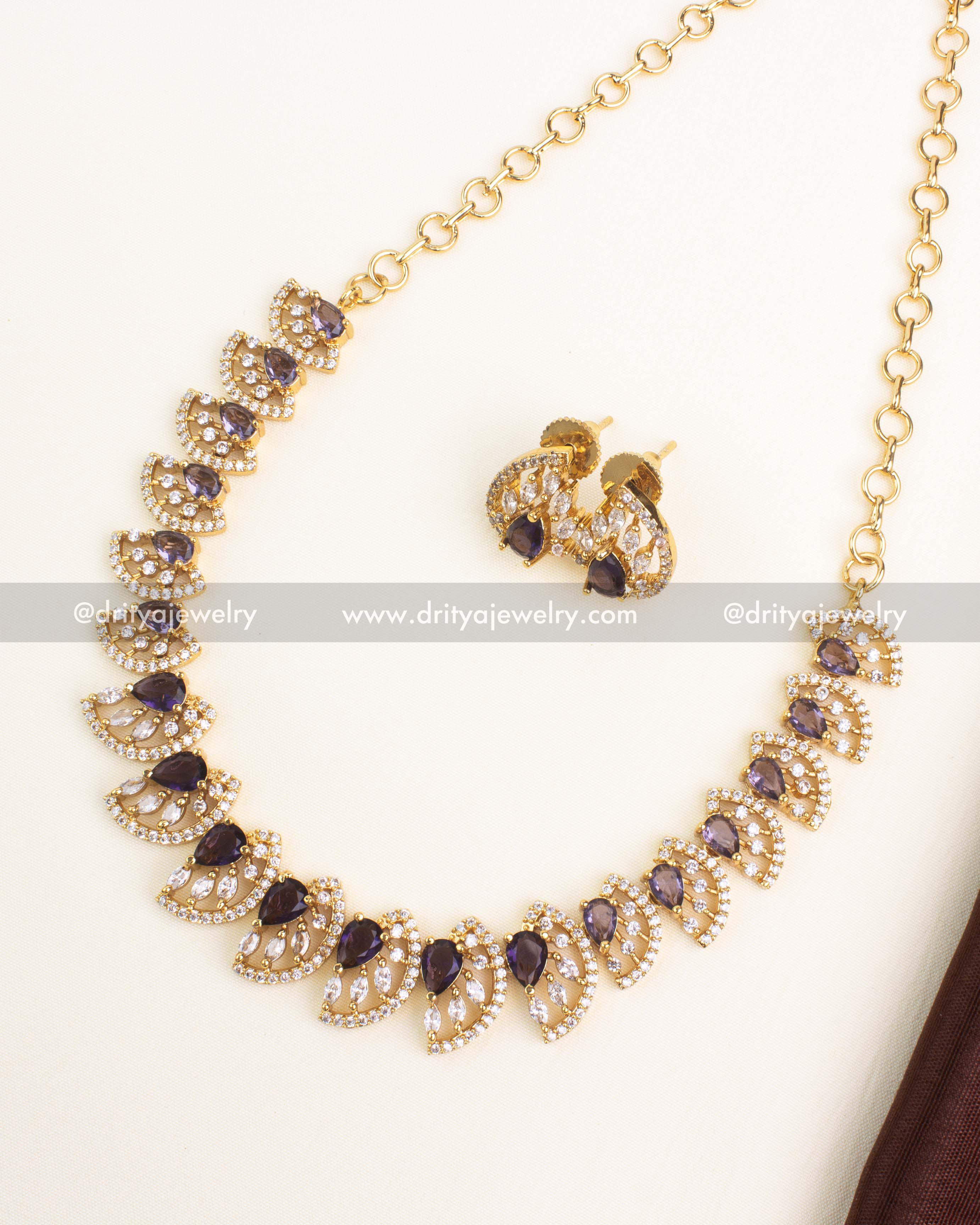 Purple CZ short necklace with gold polish and matching stud earrings.