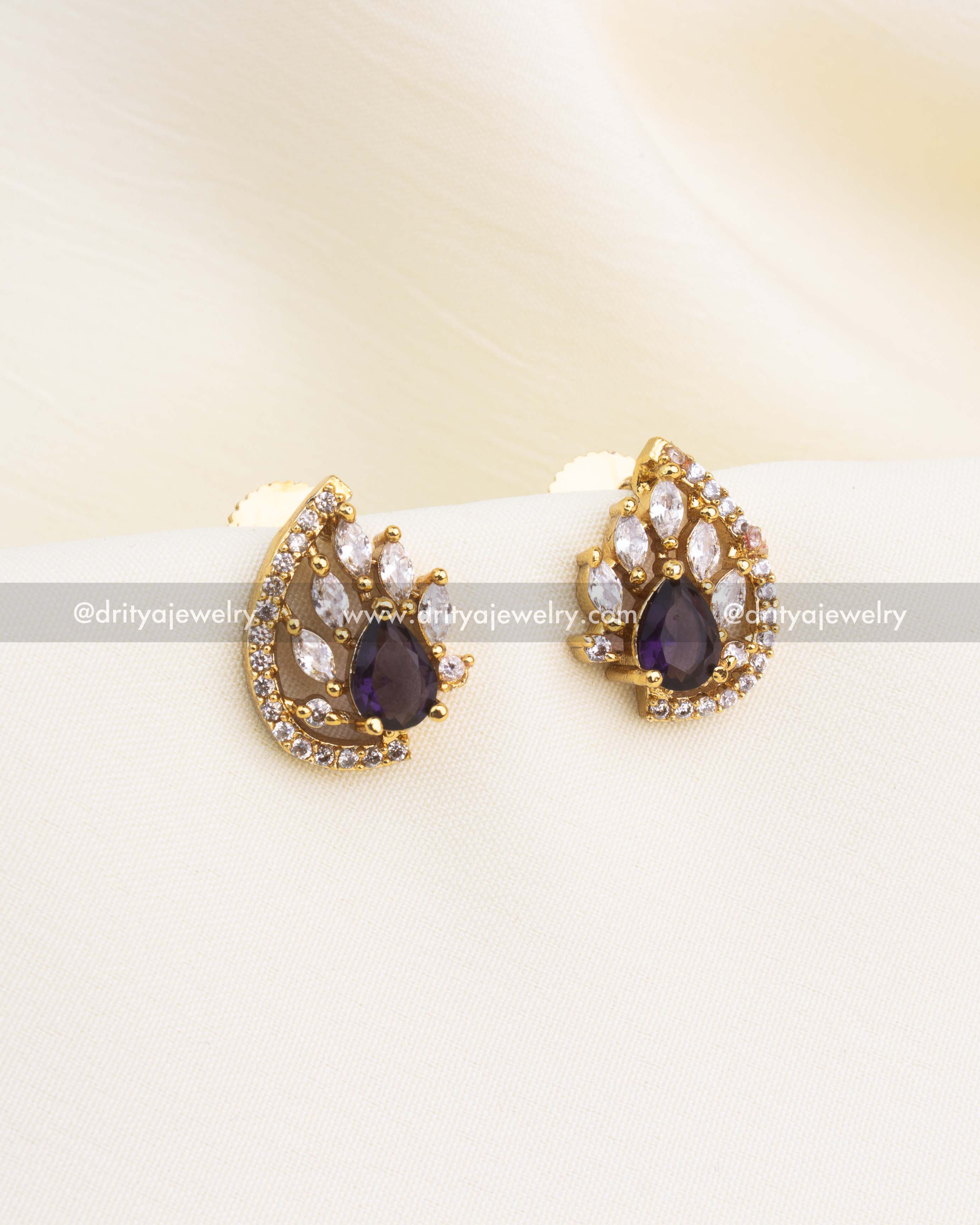 Gold-plated stud earrings with purple center stone and white CZ accents.