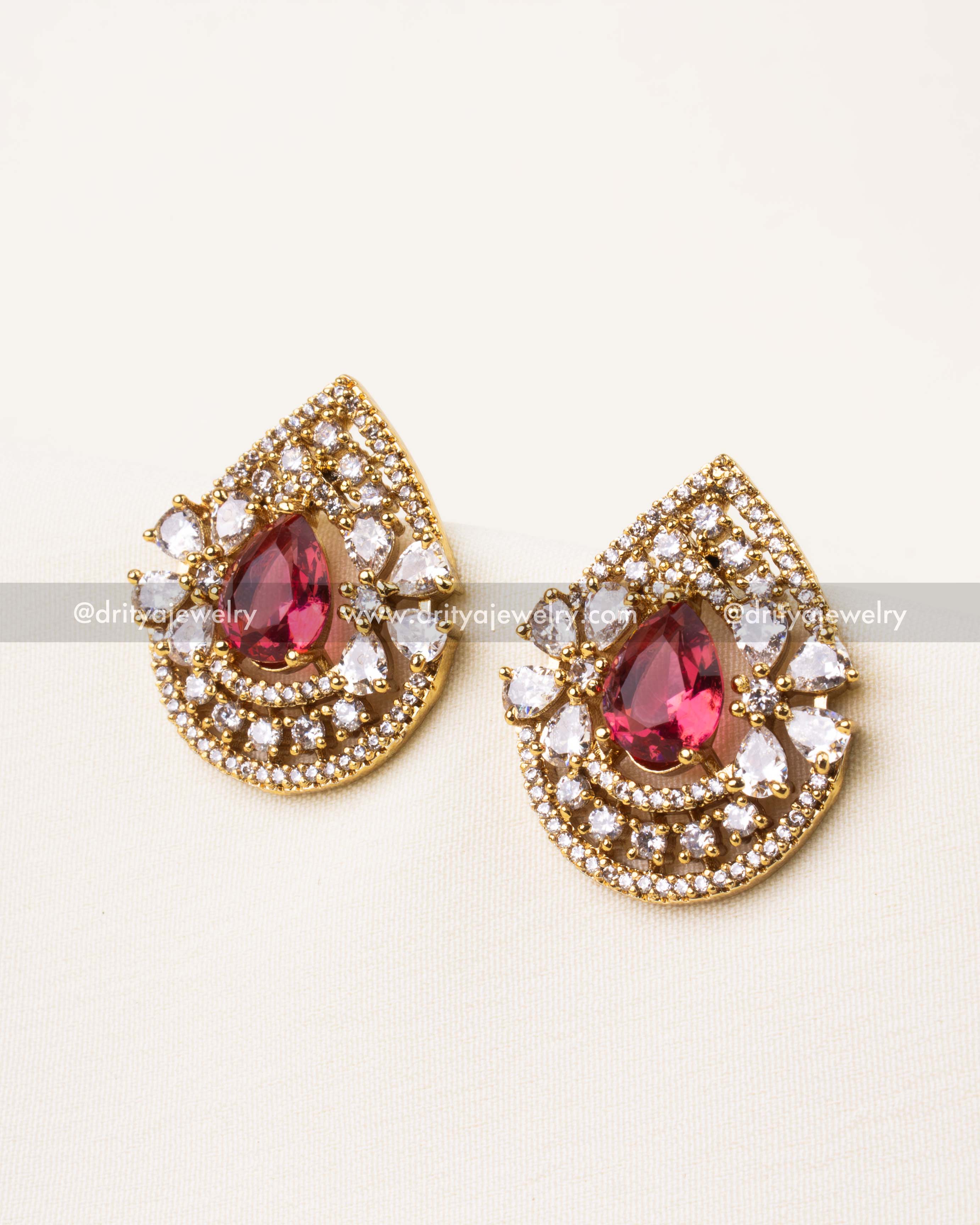 Red teardrop stud earrings with layered CZ stone halo design.
