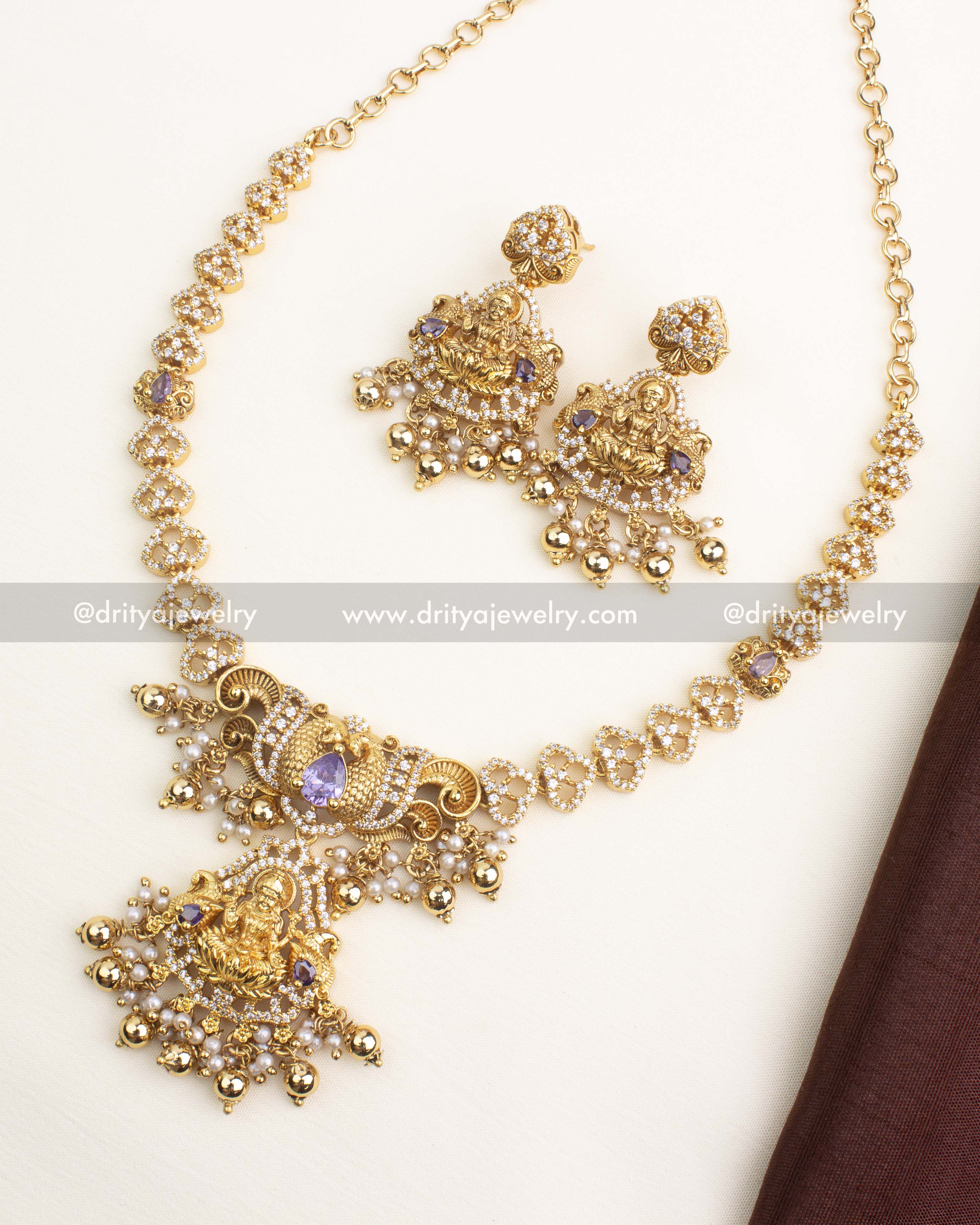 Antique gold CZ temple short necklace with purple center stone, Lakshmi pendant, and matching earrings