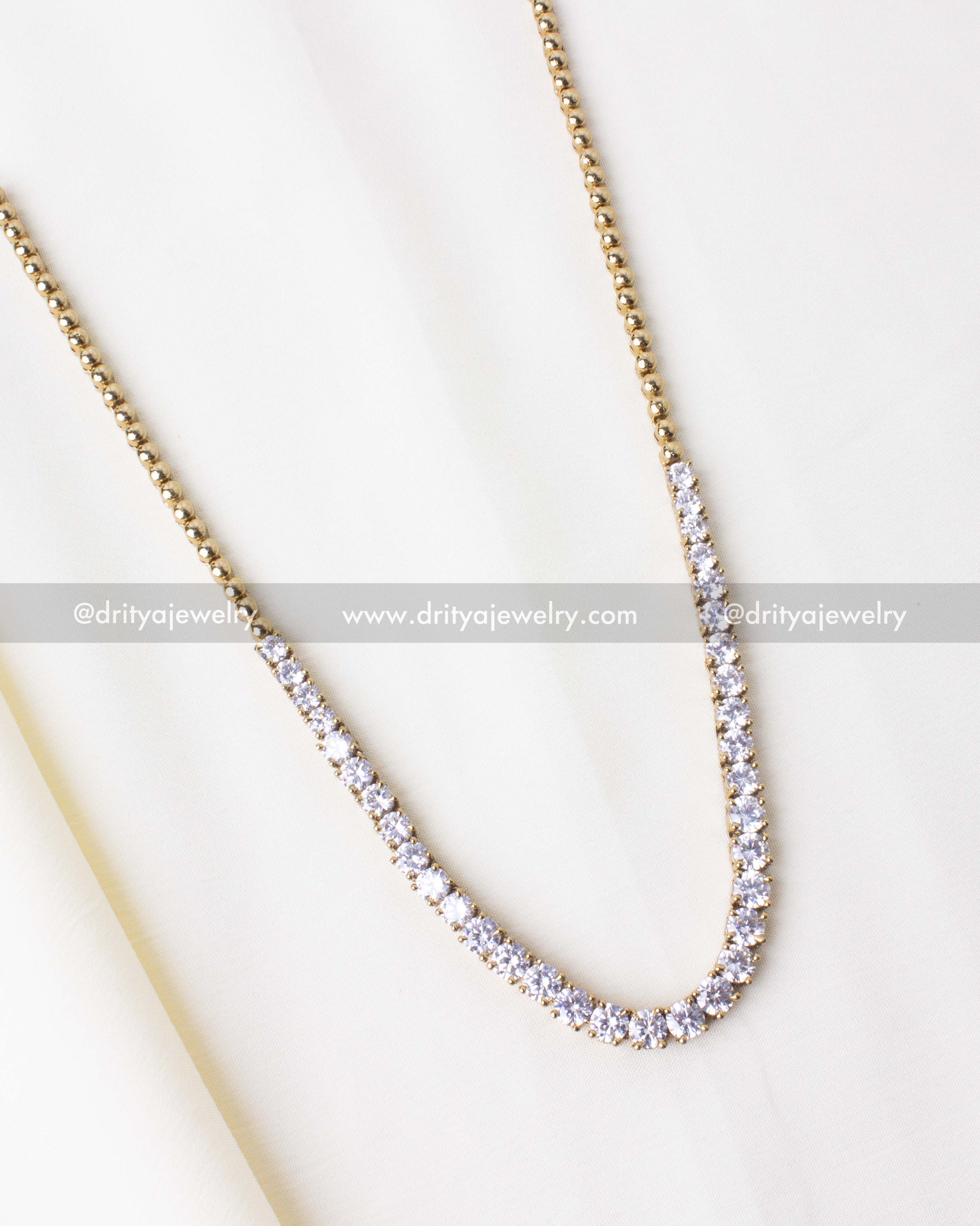 Elegant gold-tone necklace set with high-quality CZ stones.