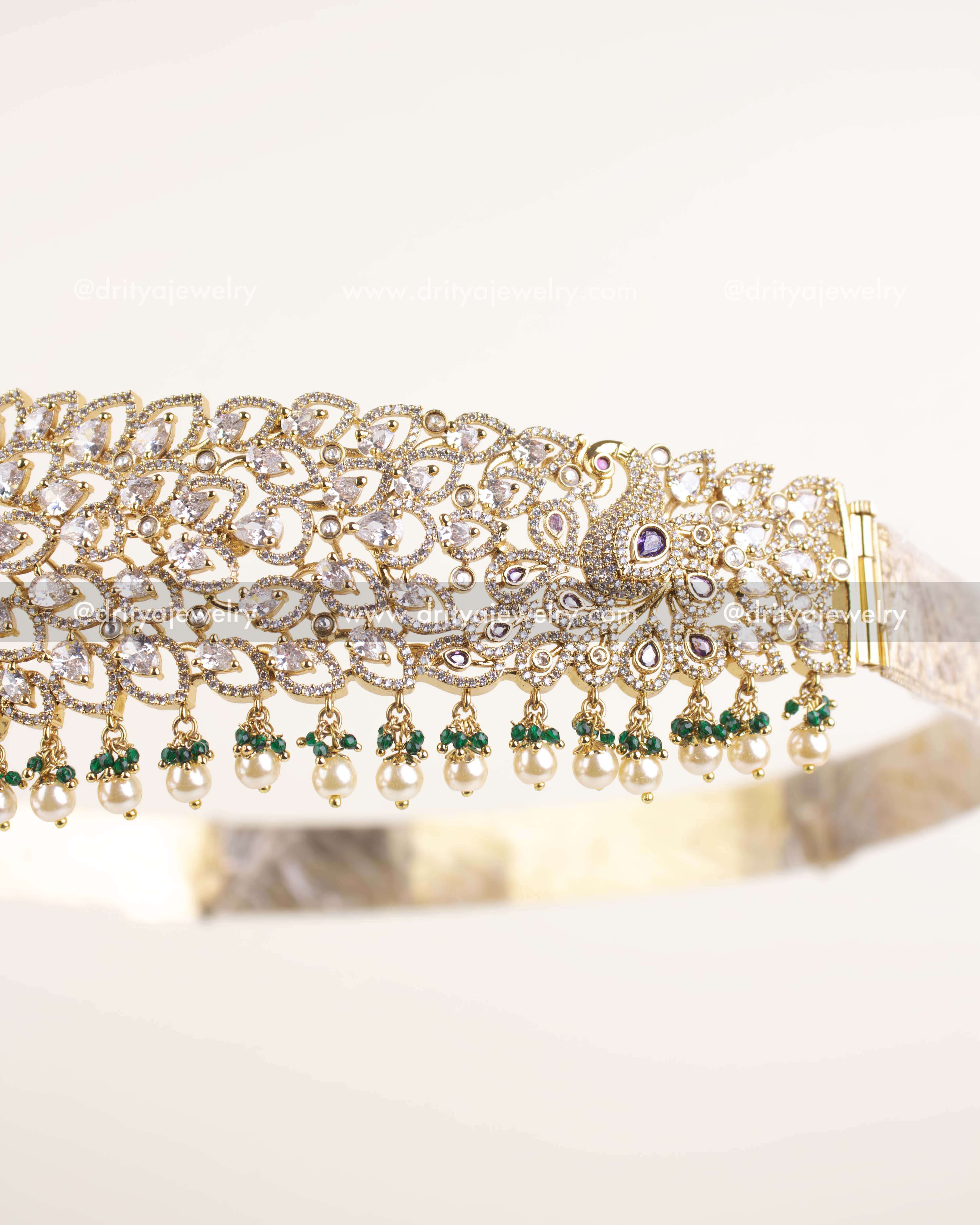 Side view of bridal waist belt showing CZ stone detailing, green bead and pearl accents.