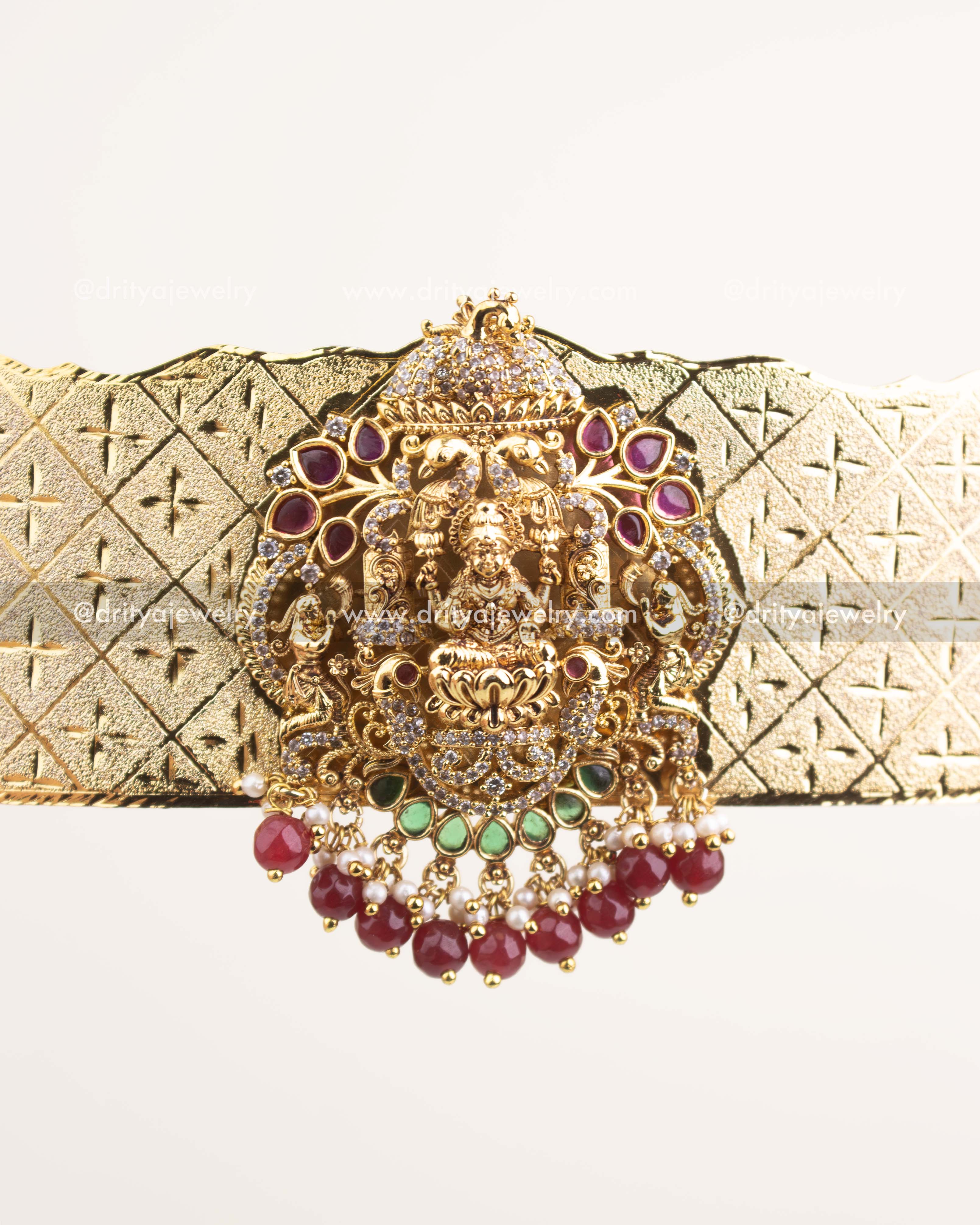 Close view of central Goddess Lakshmi carving with CZ and ruby-emerald embellishments.