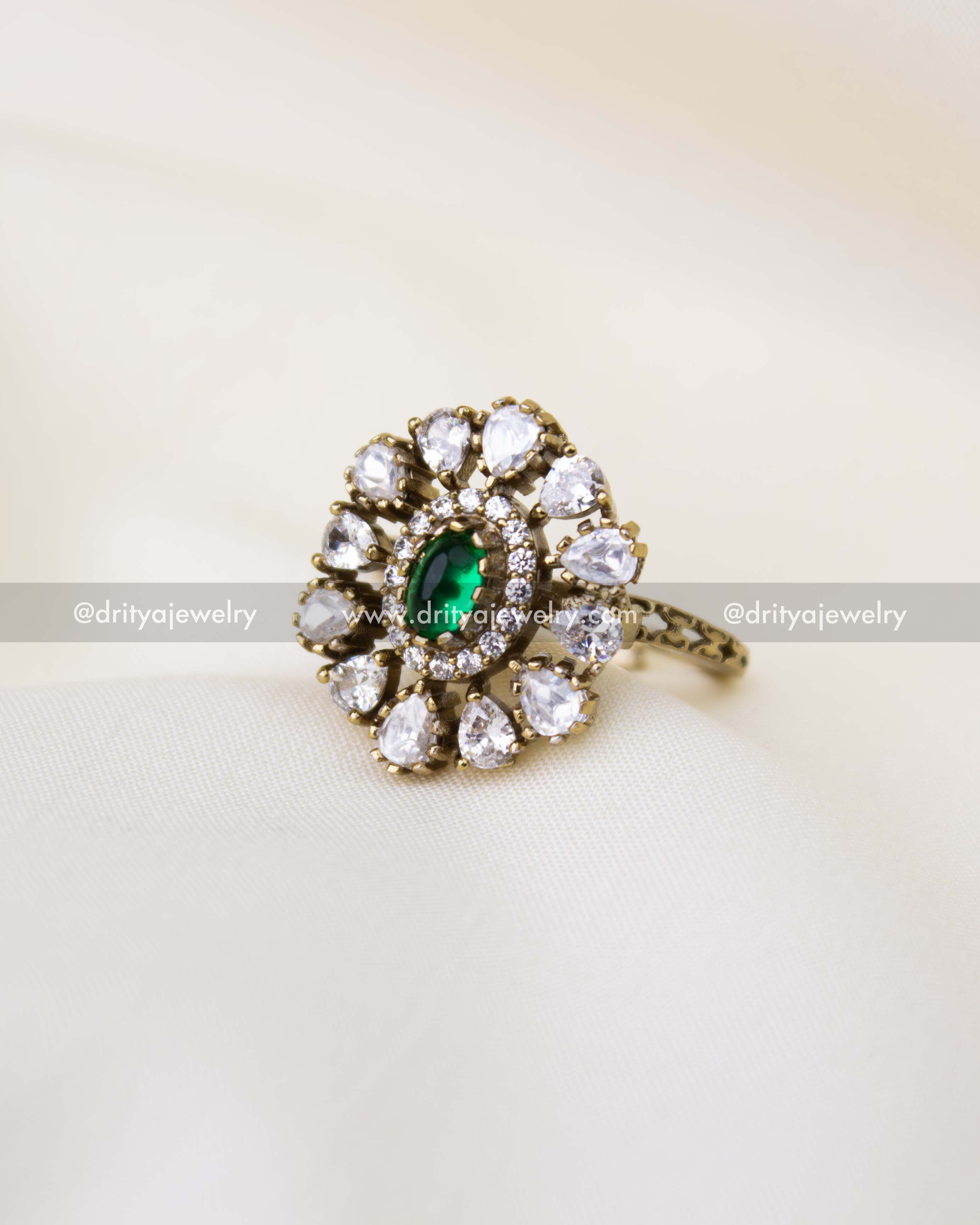 Victorian polish kundan finger ring with emerald green center stone and floral kundan design