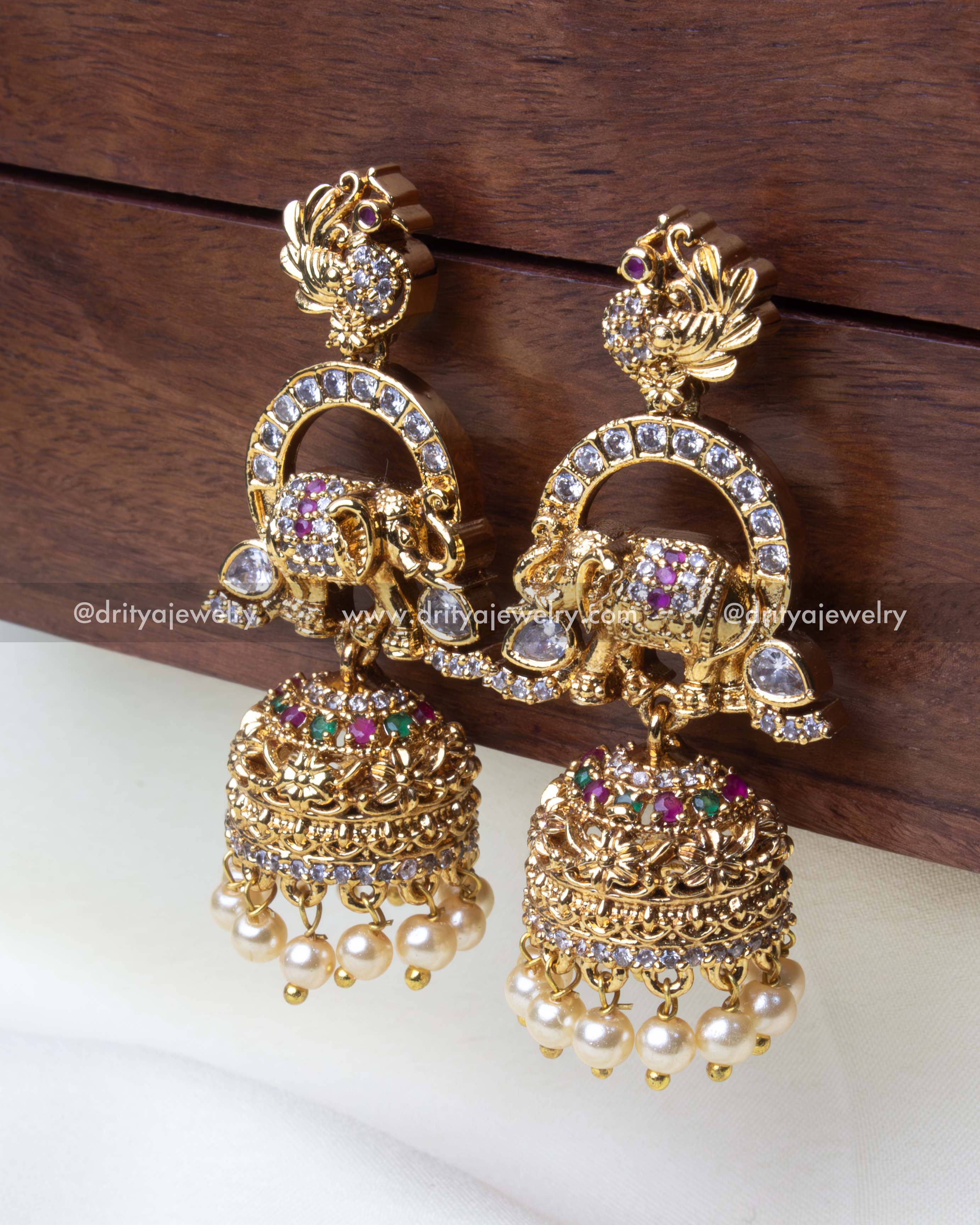 Elegant Jhumka earrings with intricate elephant motifs, multicolored stones, and pearl accents.