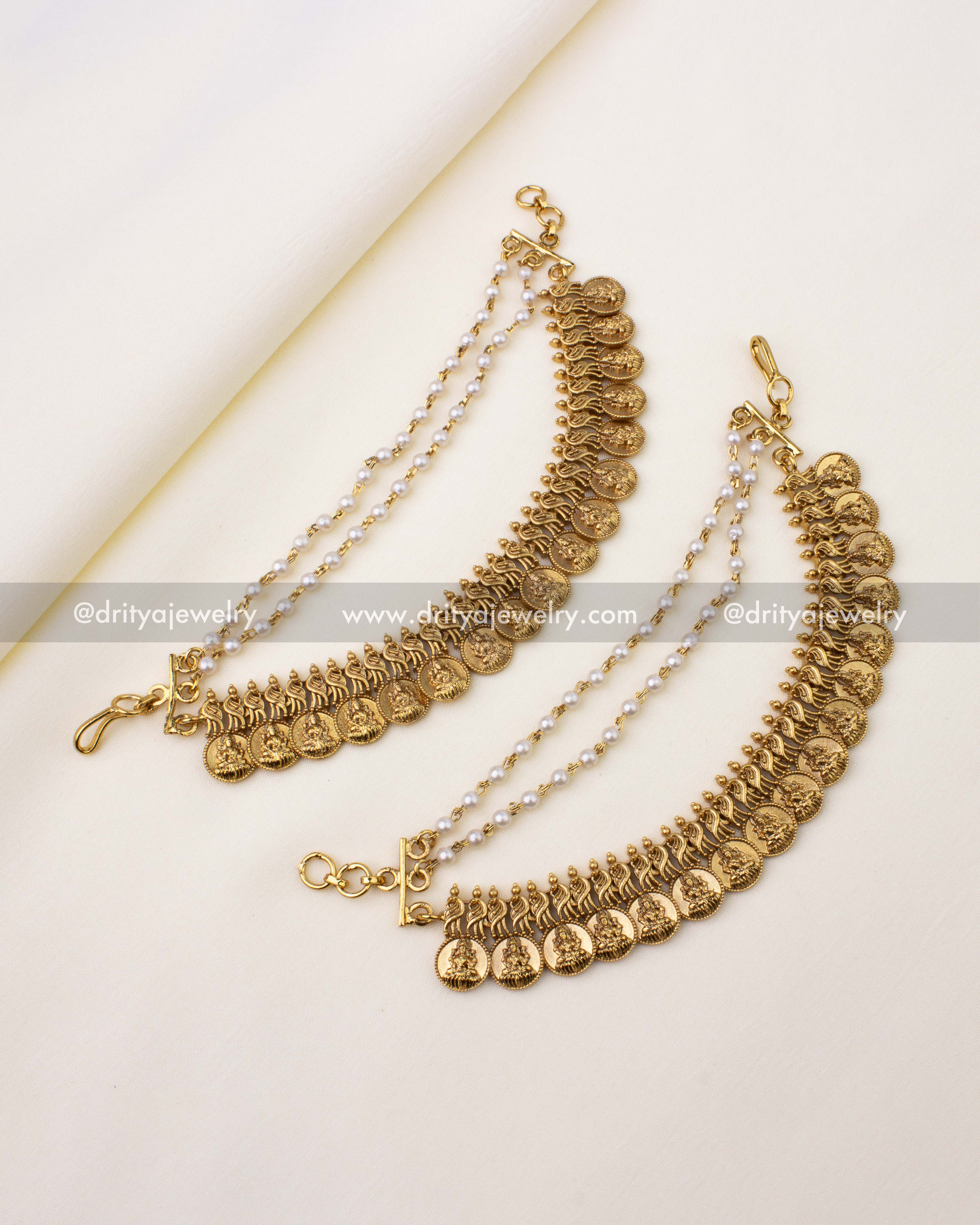 Antique gold champa swaralu with Lakshmi coin motifs, peacock designs, and pearl chains.