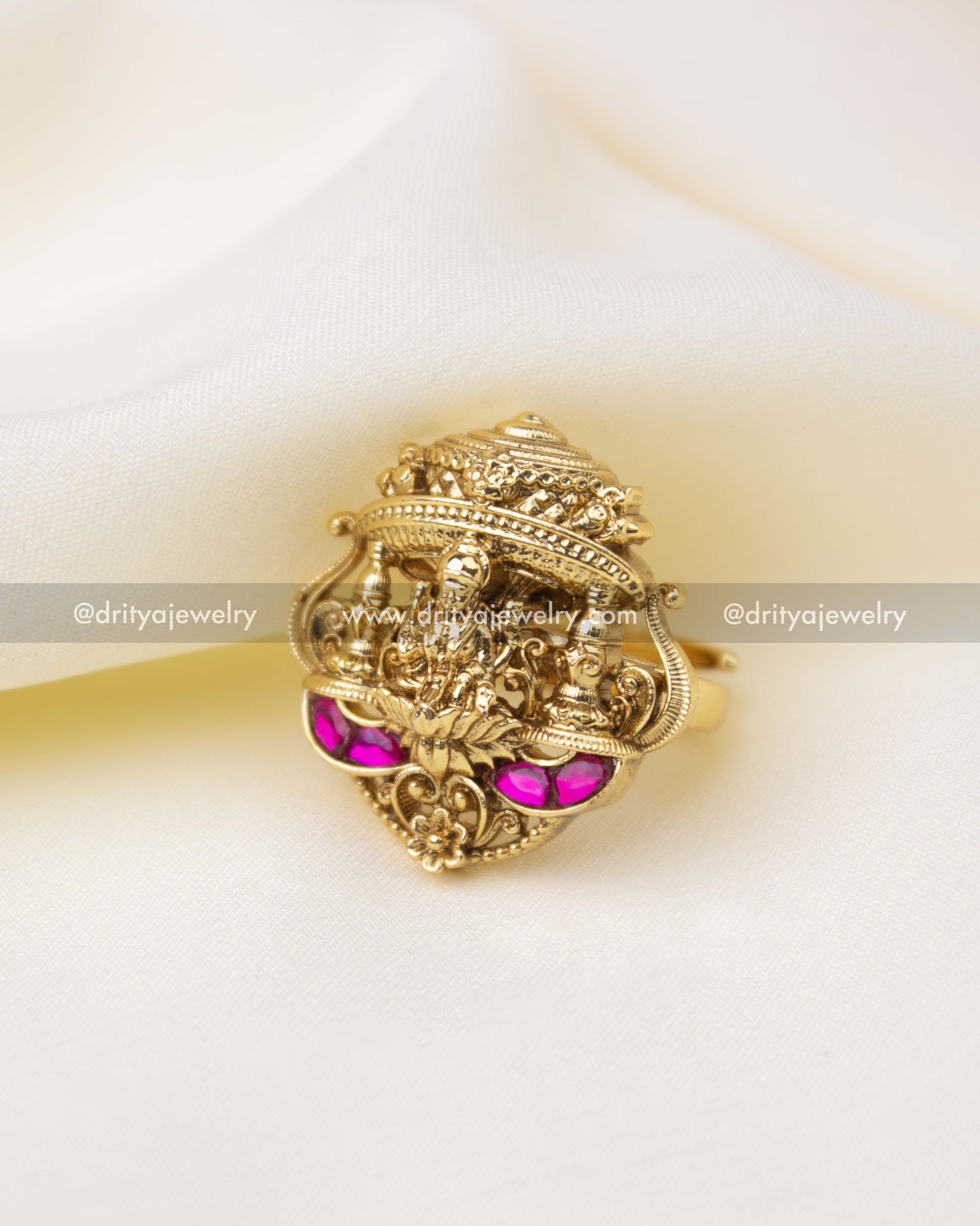 Antique gold adjustable Kemp finger ring with ruby-tone stones and temple detailing