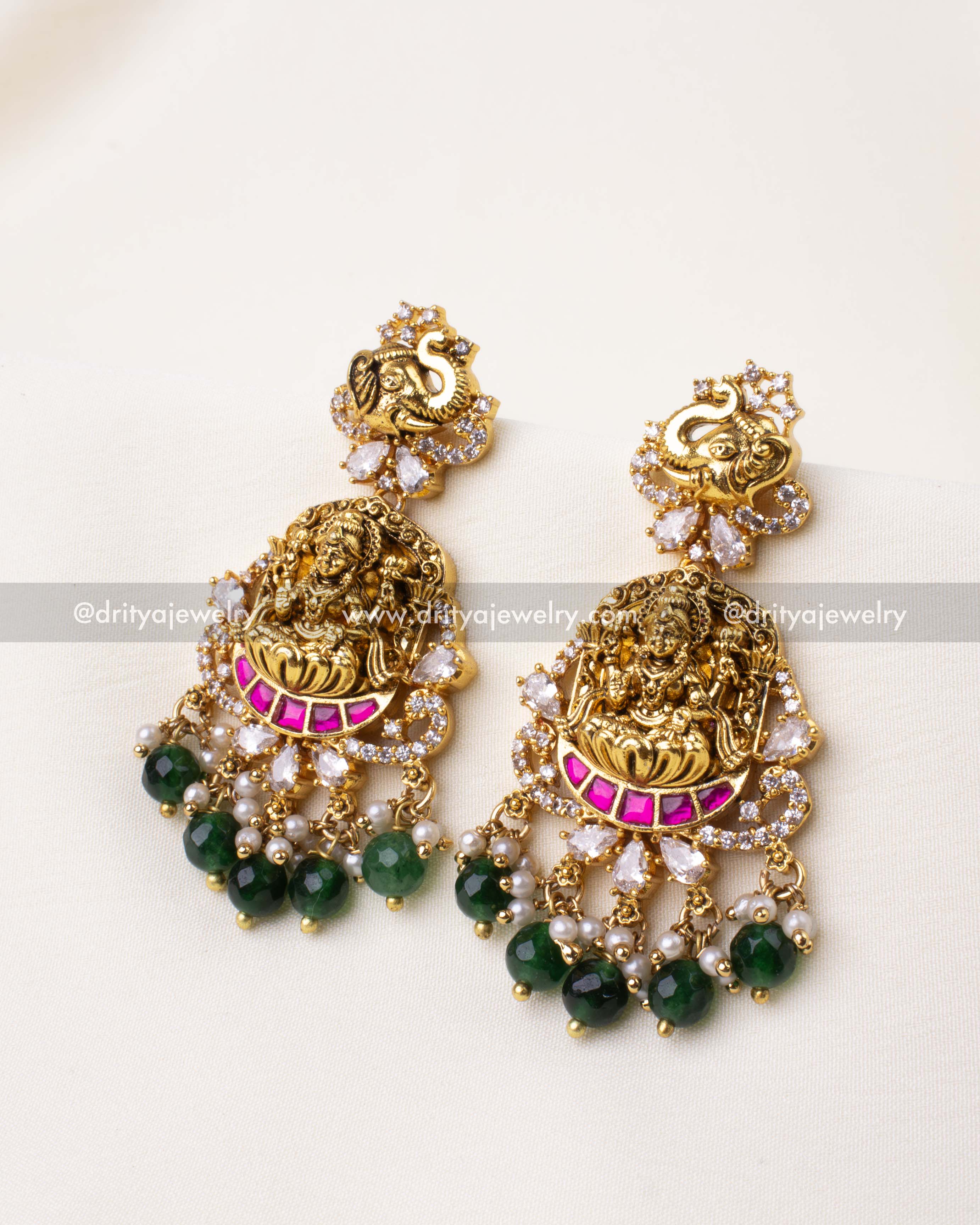 Temple-inspired dangler earrings with carved goddess motif, pink kemp stones, green beads, and pearl drops.