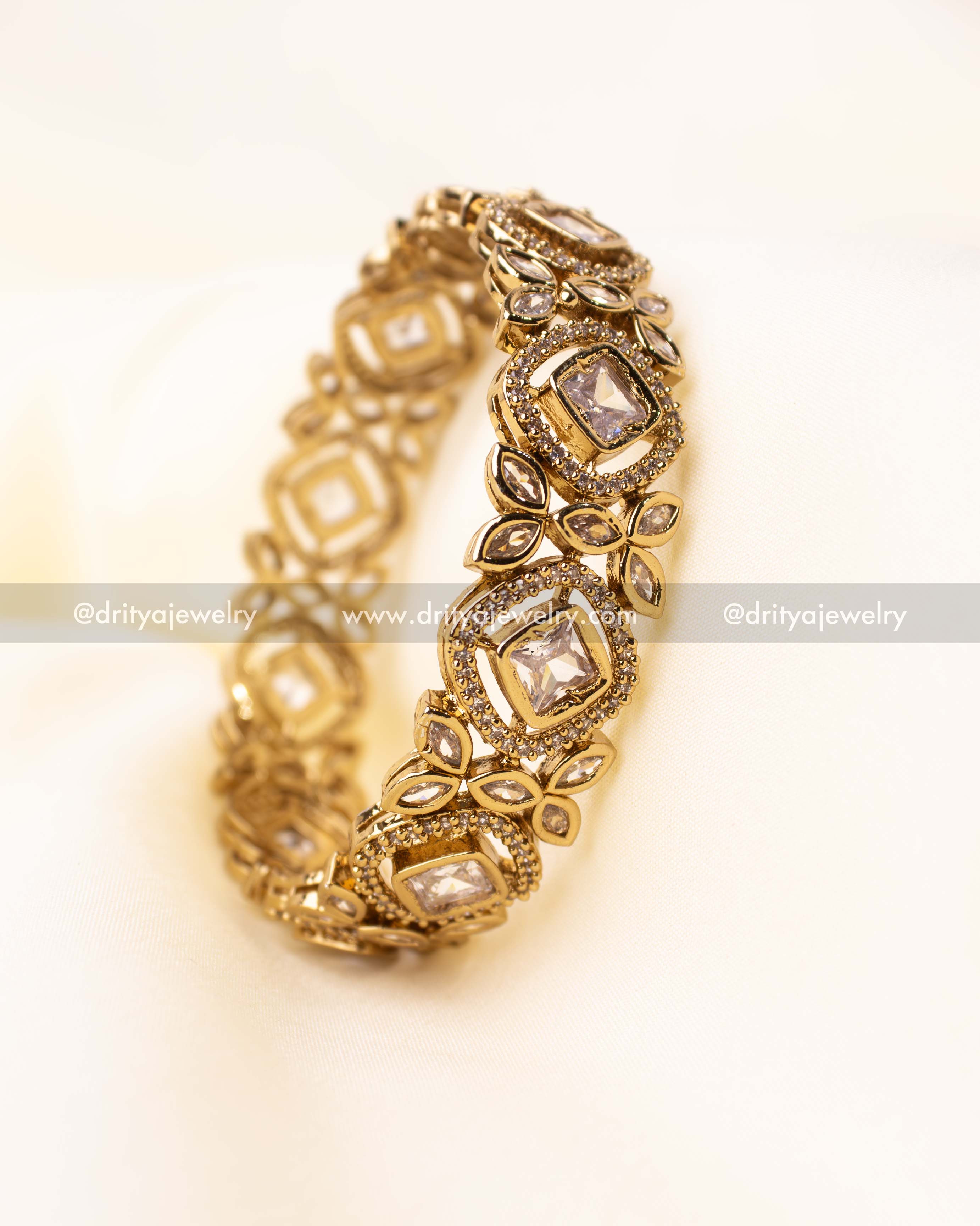 Single antique finish Kundan bangle with floral and square stone motifs.