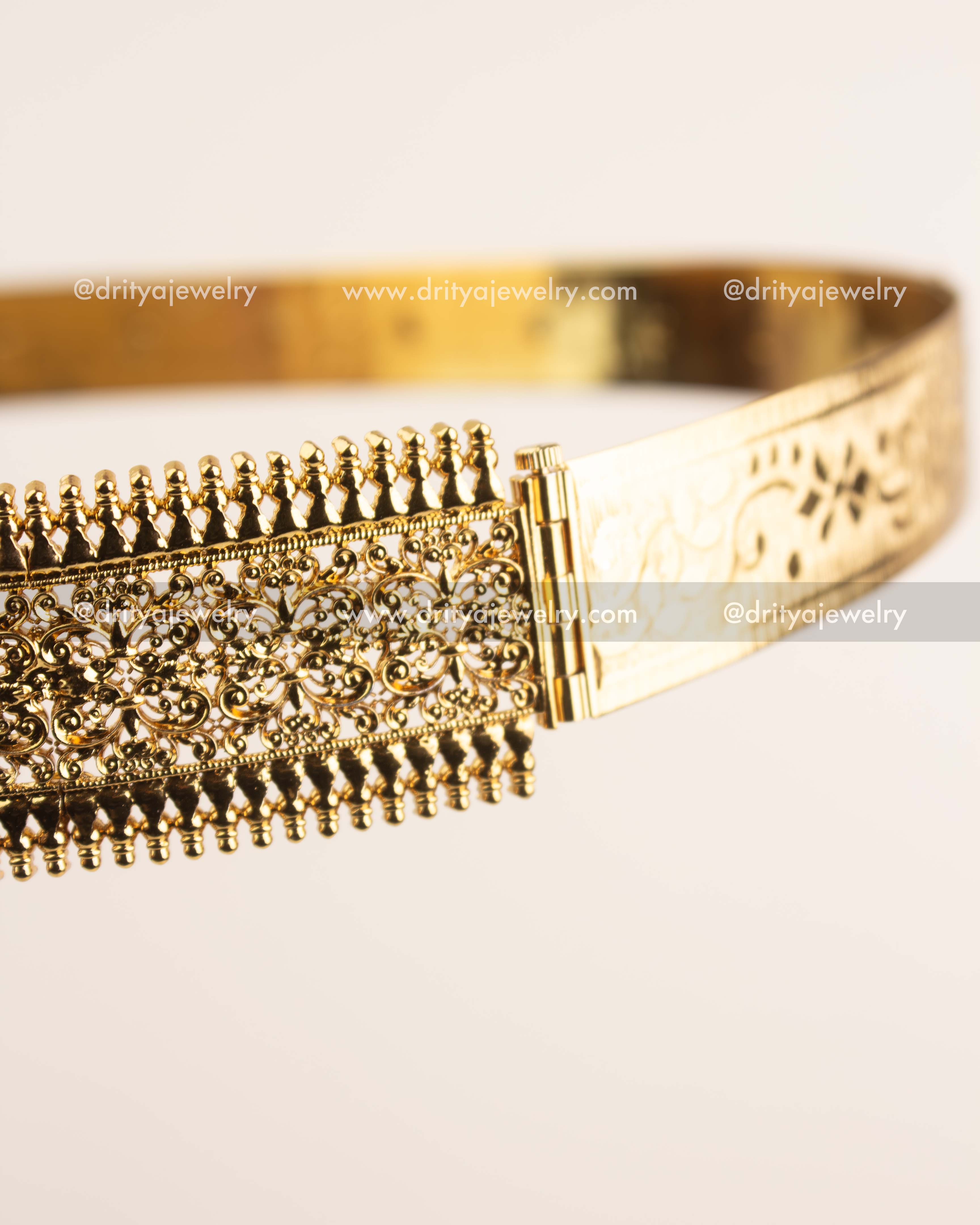 Side view showing intricate filigree pattern and antique gold polish of waist belt.