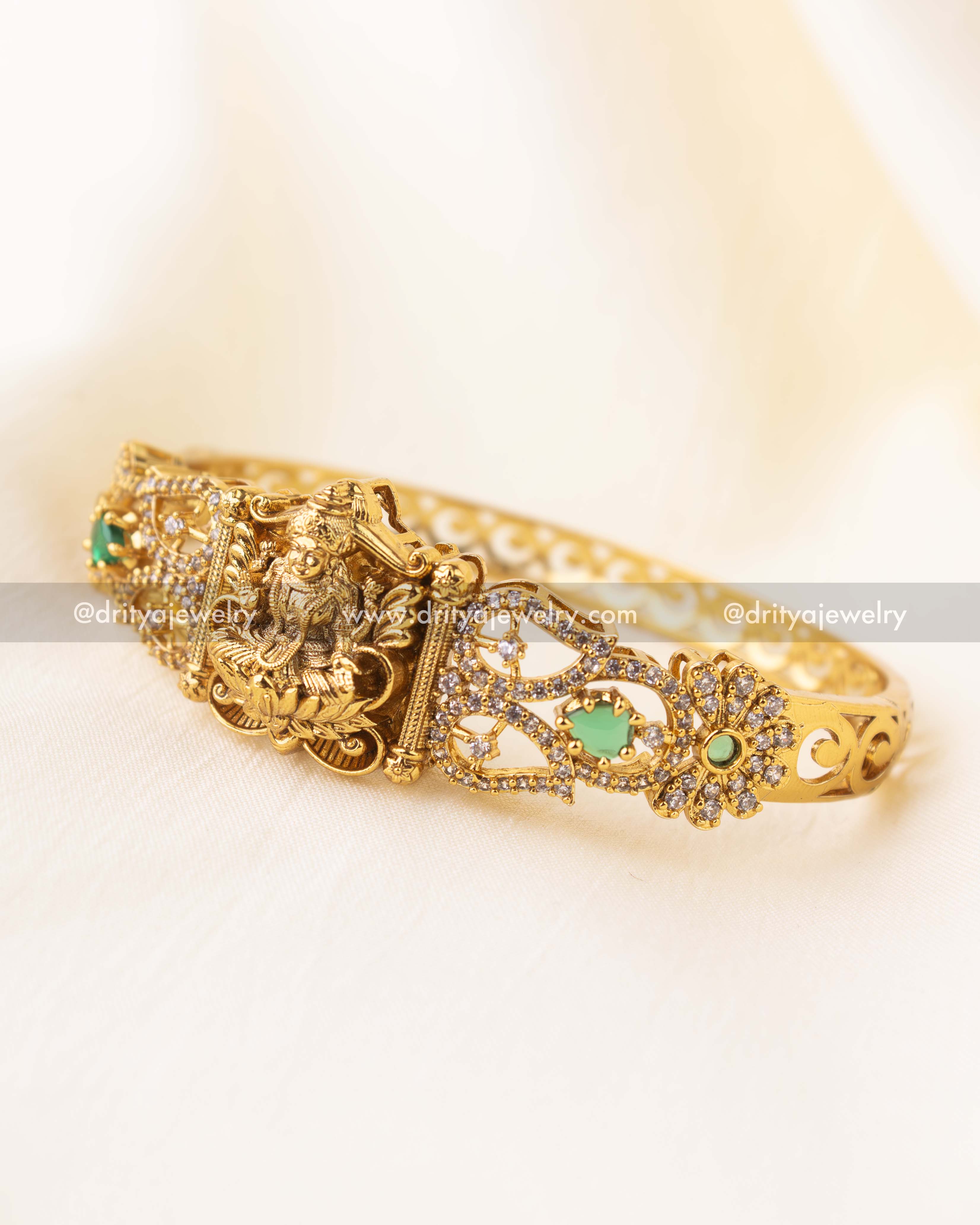 Openable temple-style kada with goddess Lakshmi motif and green stone accents