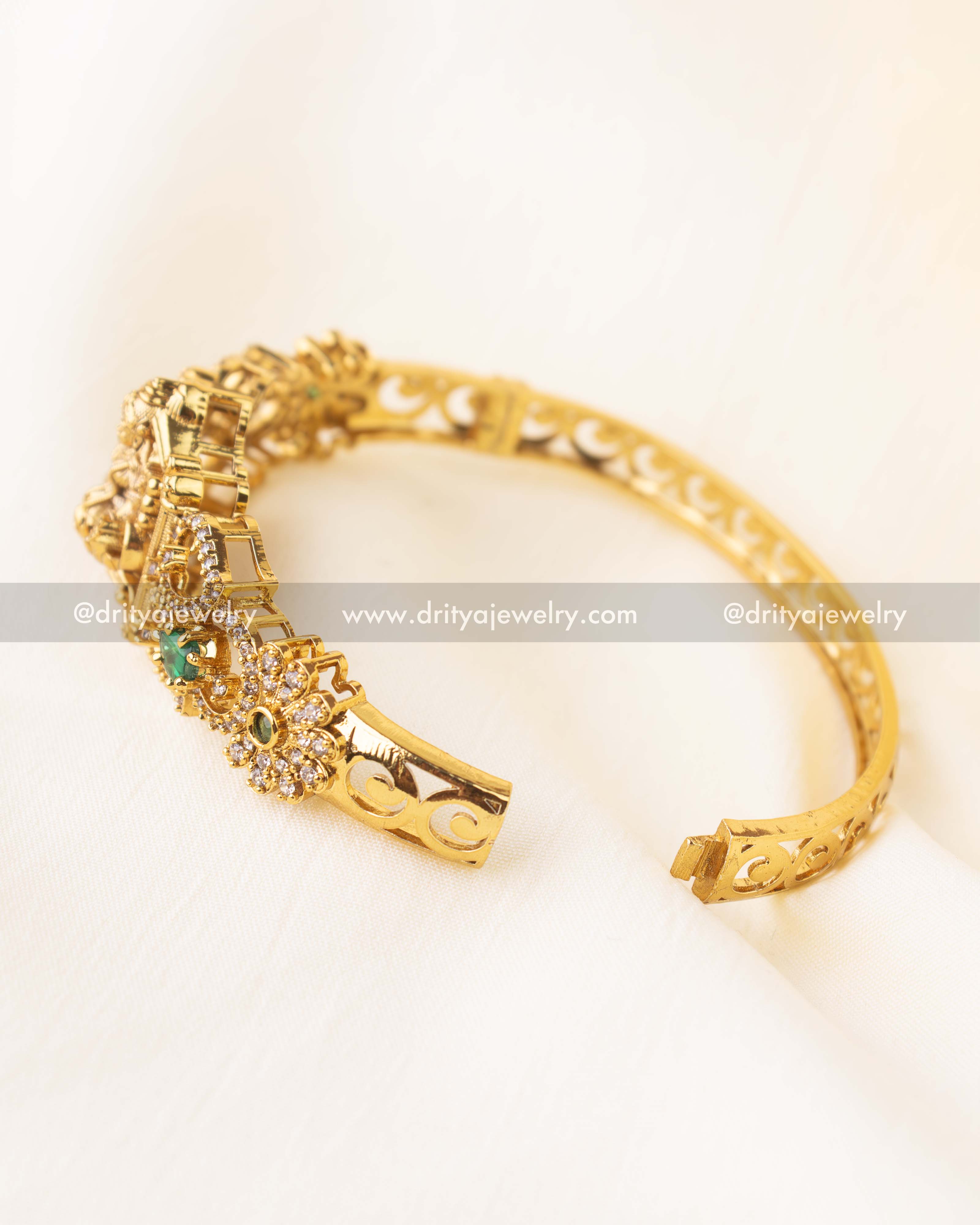 Openable temple-style kada with goddess Lakshmi motif and green stone accents