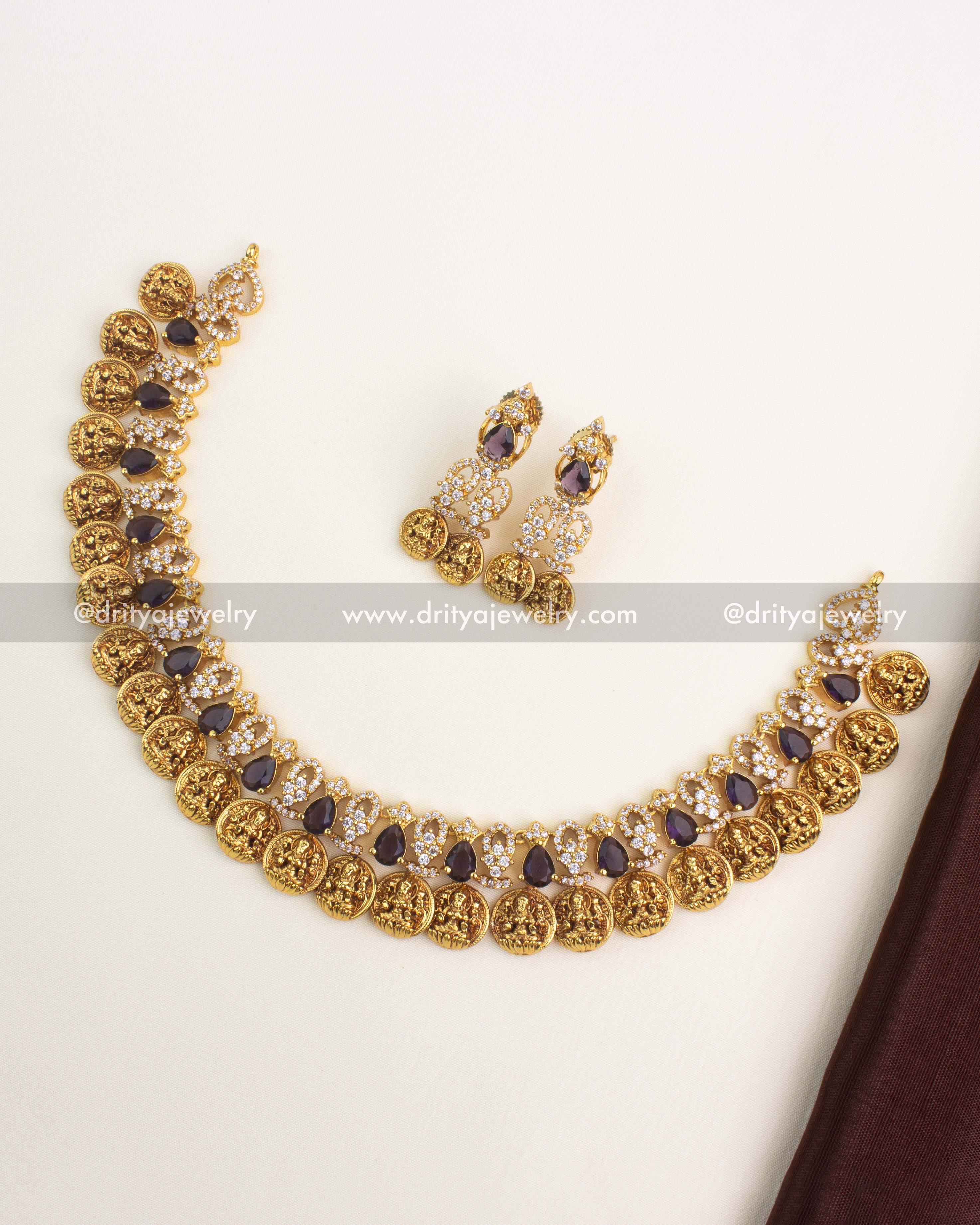 Gold-plated Lakshmi coin short necklace with CZ stones and purple tear-drop accents.