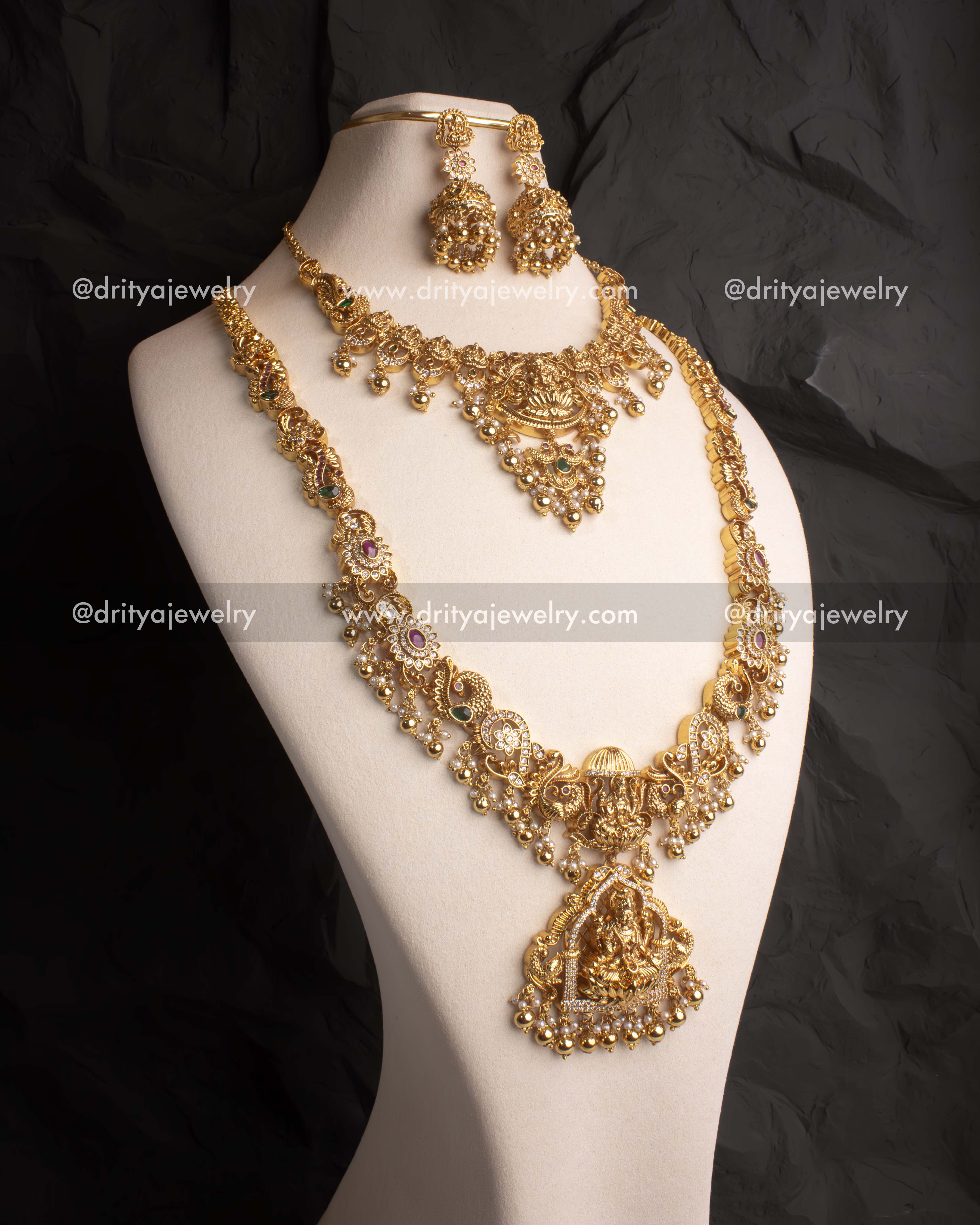 Gold-plated Nakshi long necklace set with intricate deity carvings, Kundan stones, and pearl drops.