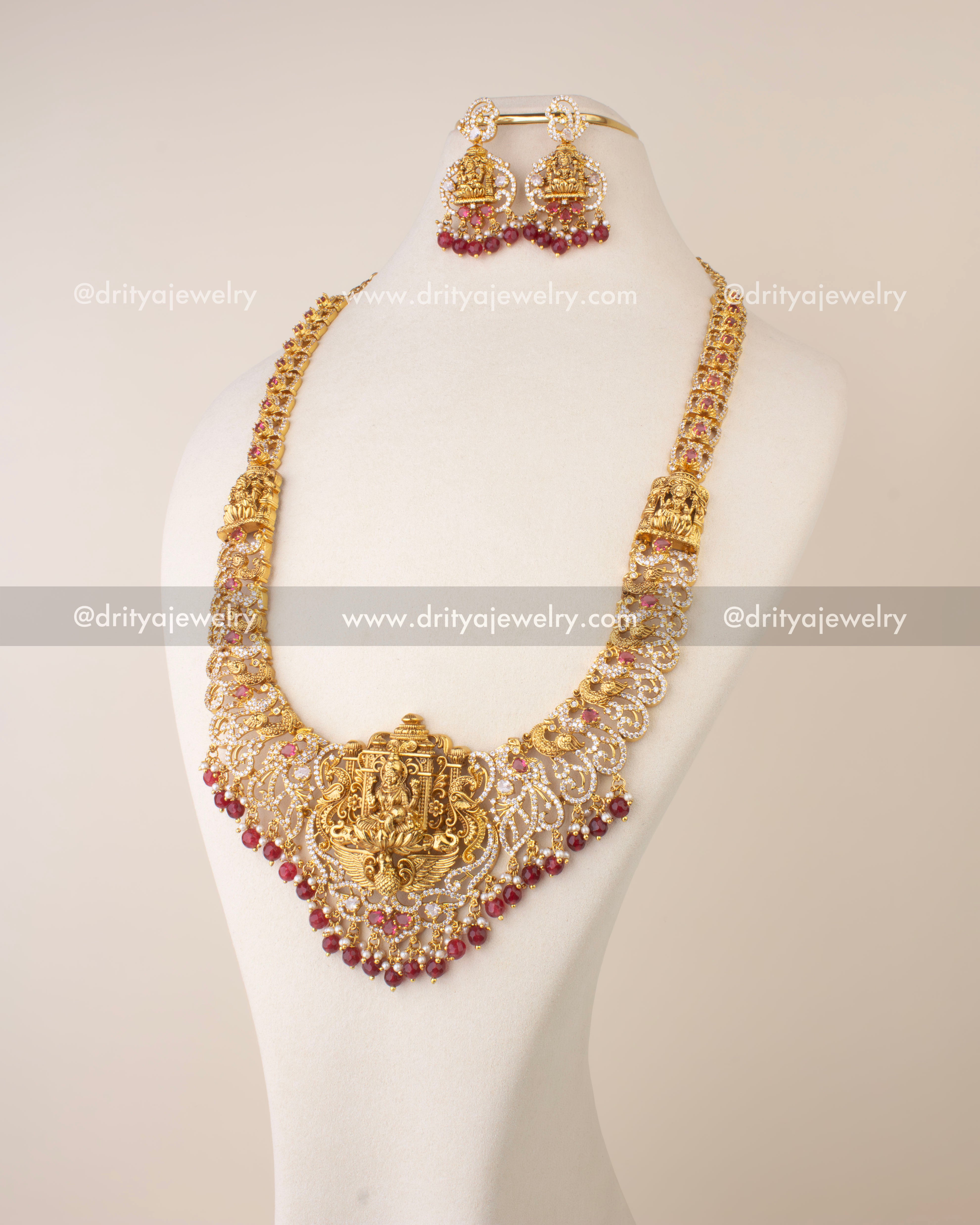 Traditional Nakshi long necklace featuring Goddess Lakshmi motif with CZ stones and ruby red bead hangings.