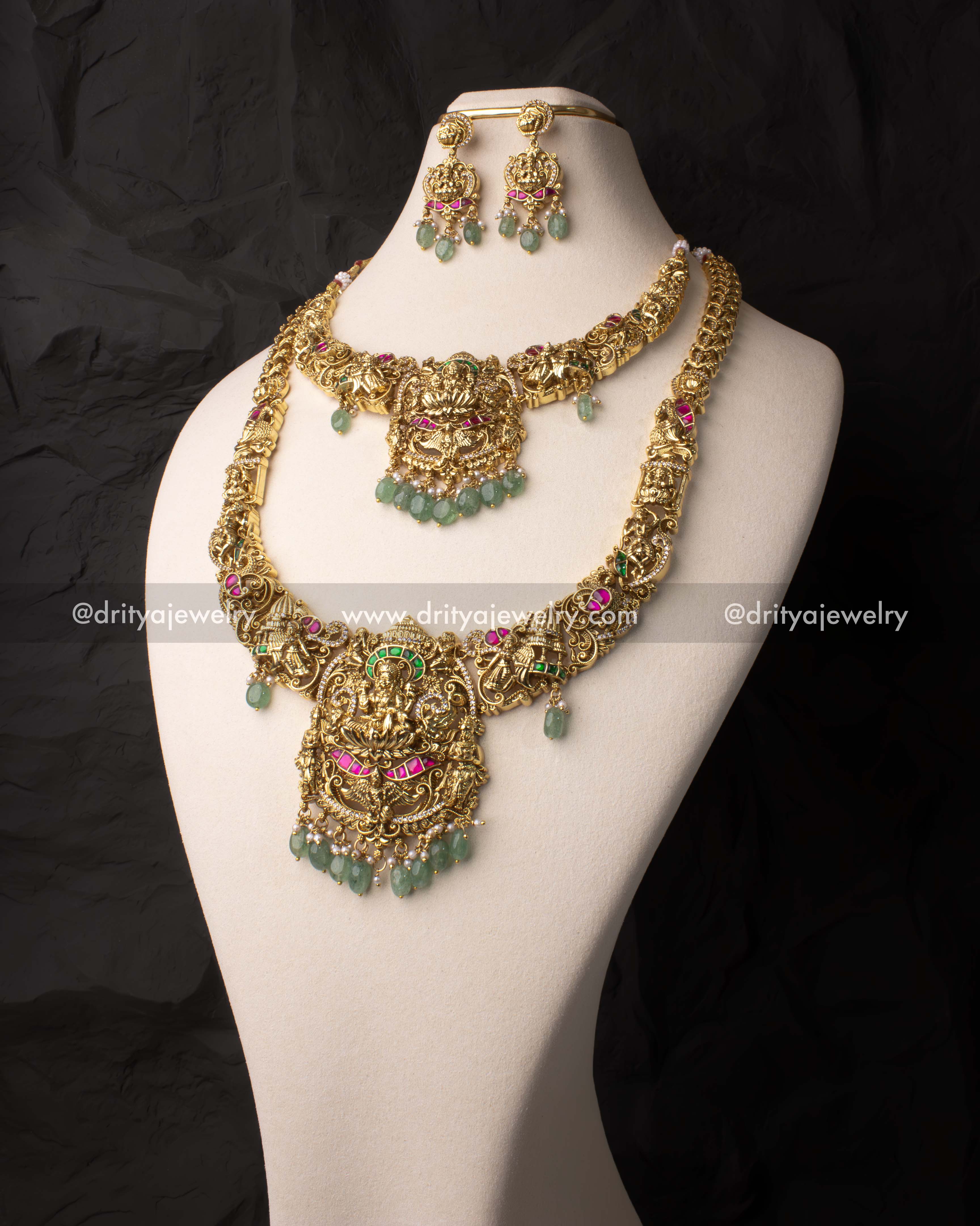 Traditional Nakshi long and short haram set with deity motifs, kemp stones, and green beads.
