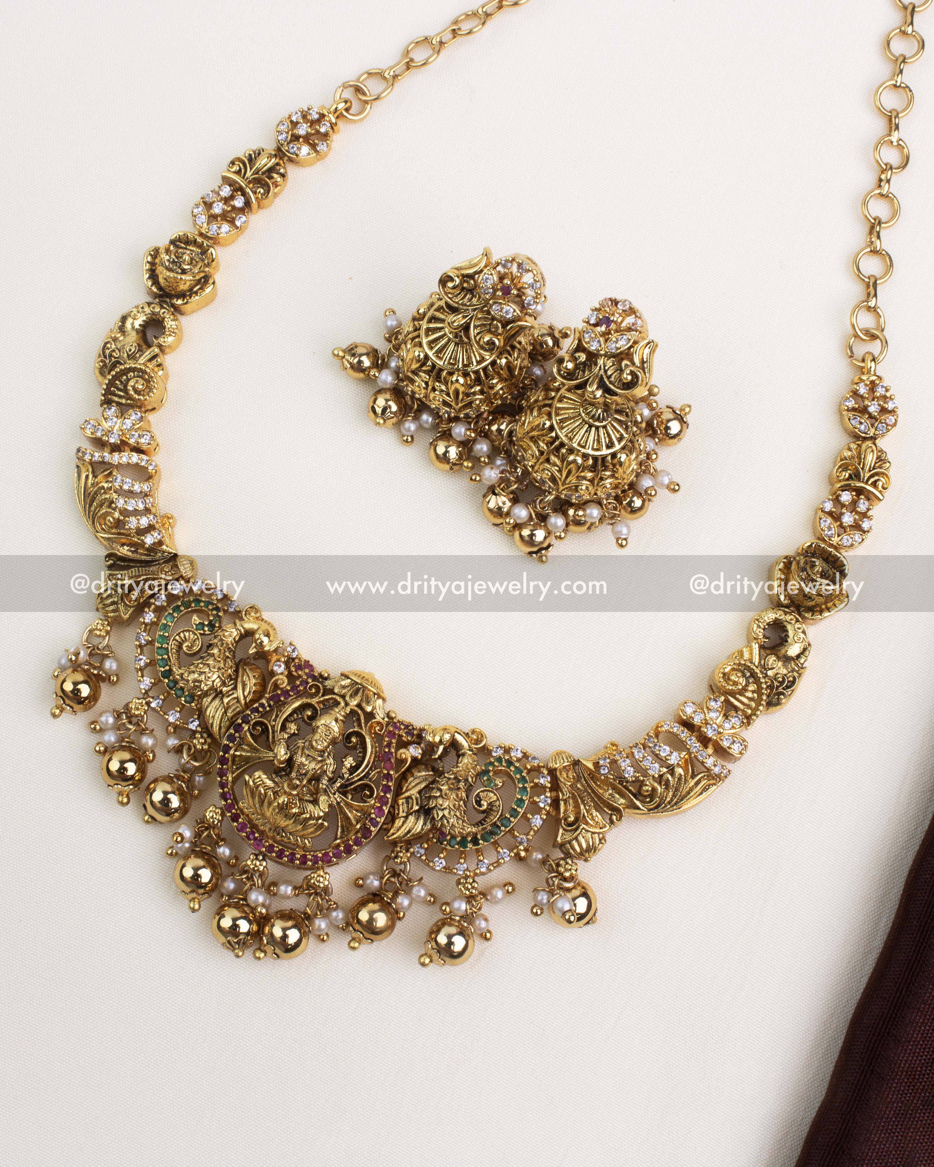 Antique gold temple necklace with Lakshmi motif, peacock design, and gold ball danglings.