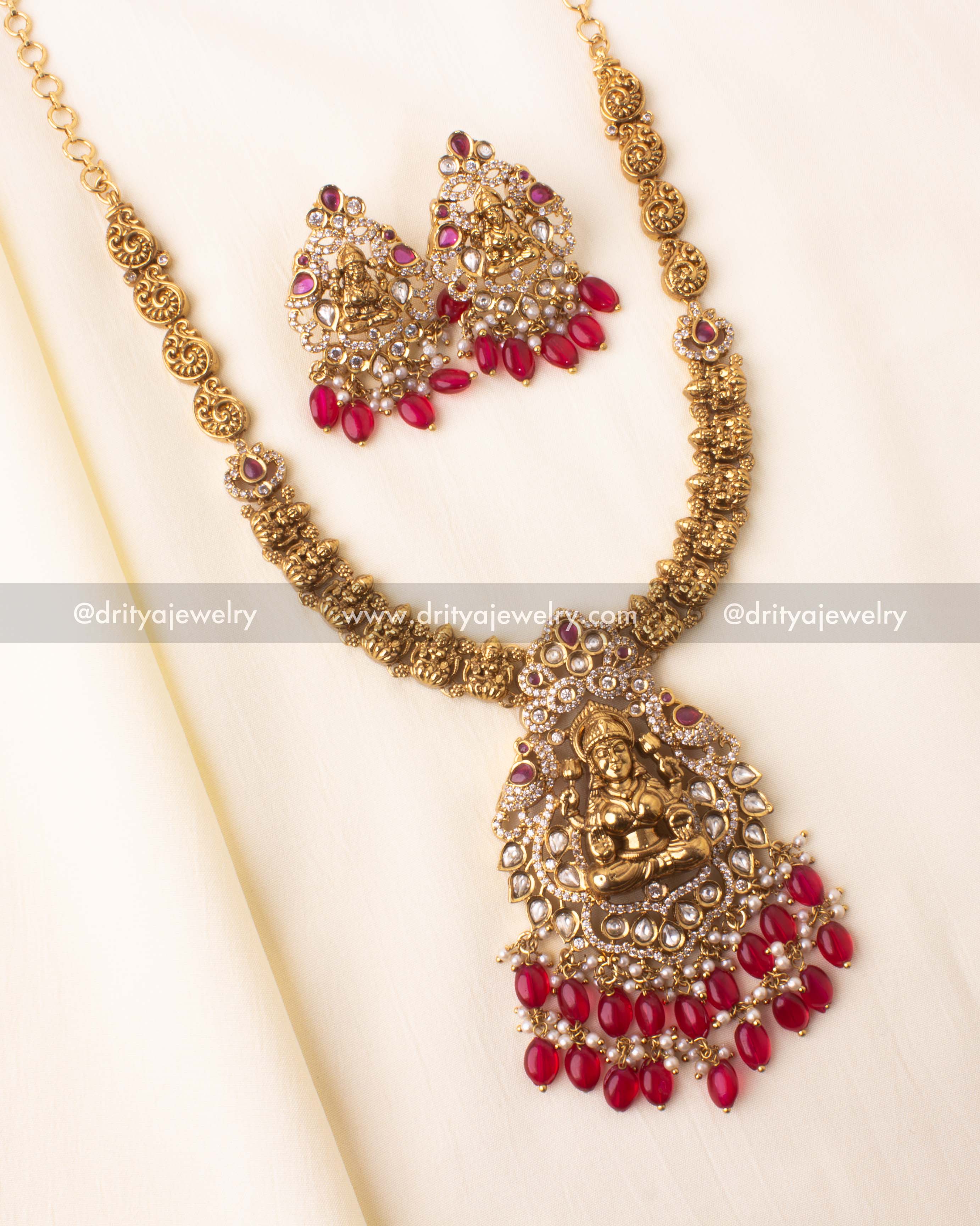 Antique gold Nakshi short necklace featuring a central Lakshmi pendant with red beads and kundan stones.