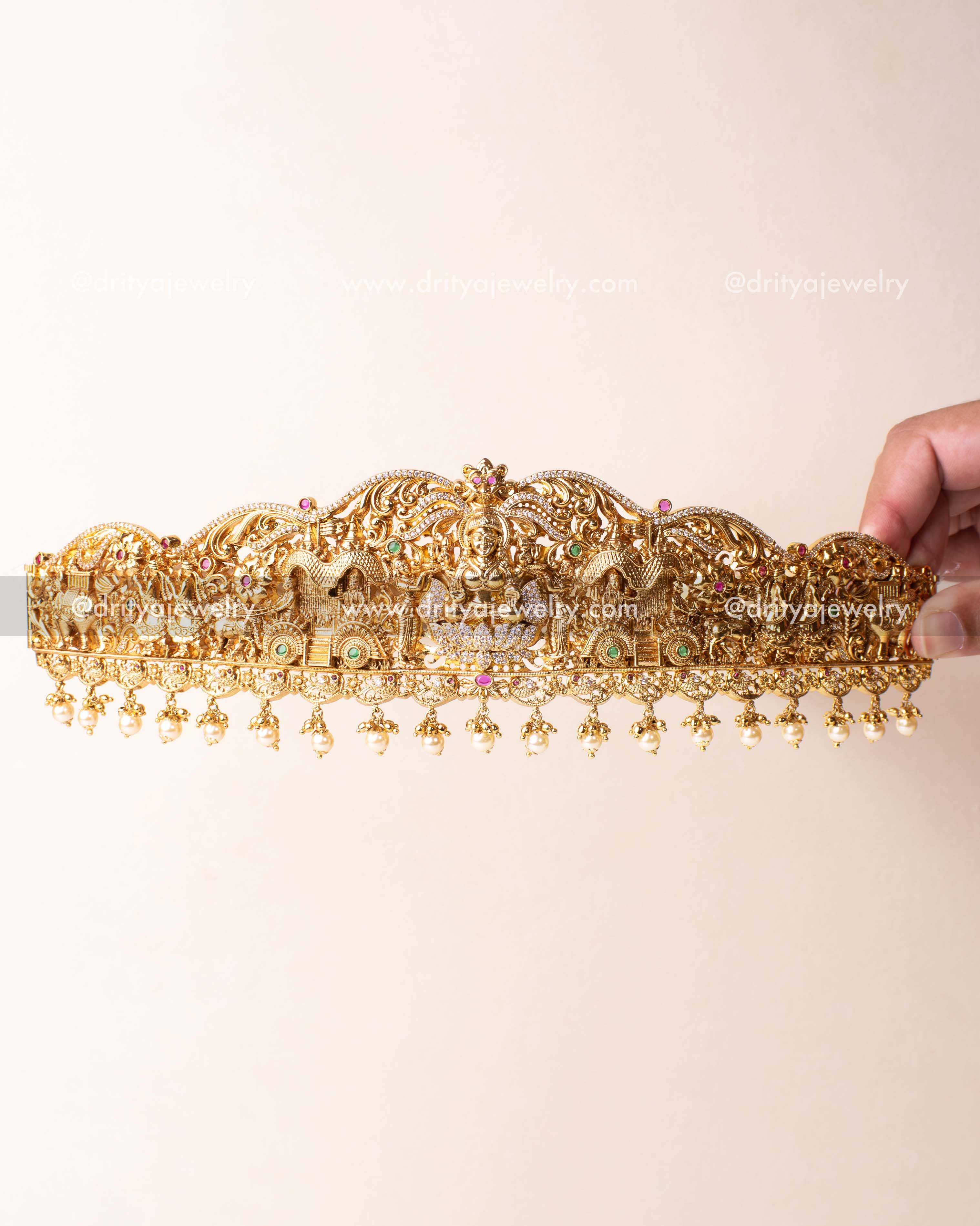 Traditional waist belt with goddess Lakshmi and temple motif detailing in antique gold finish.