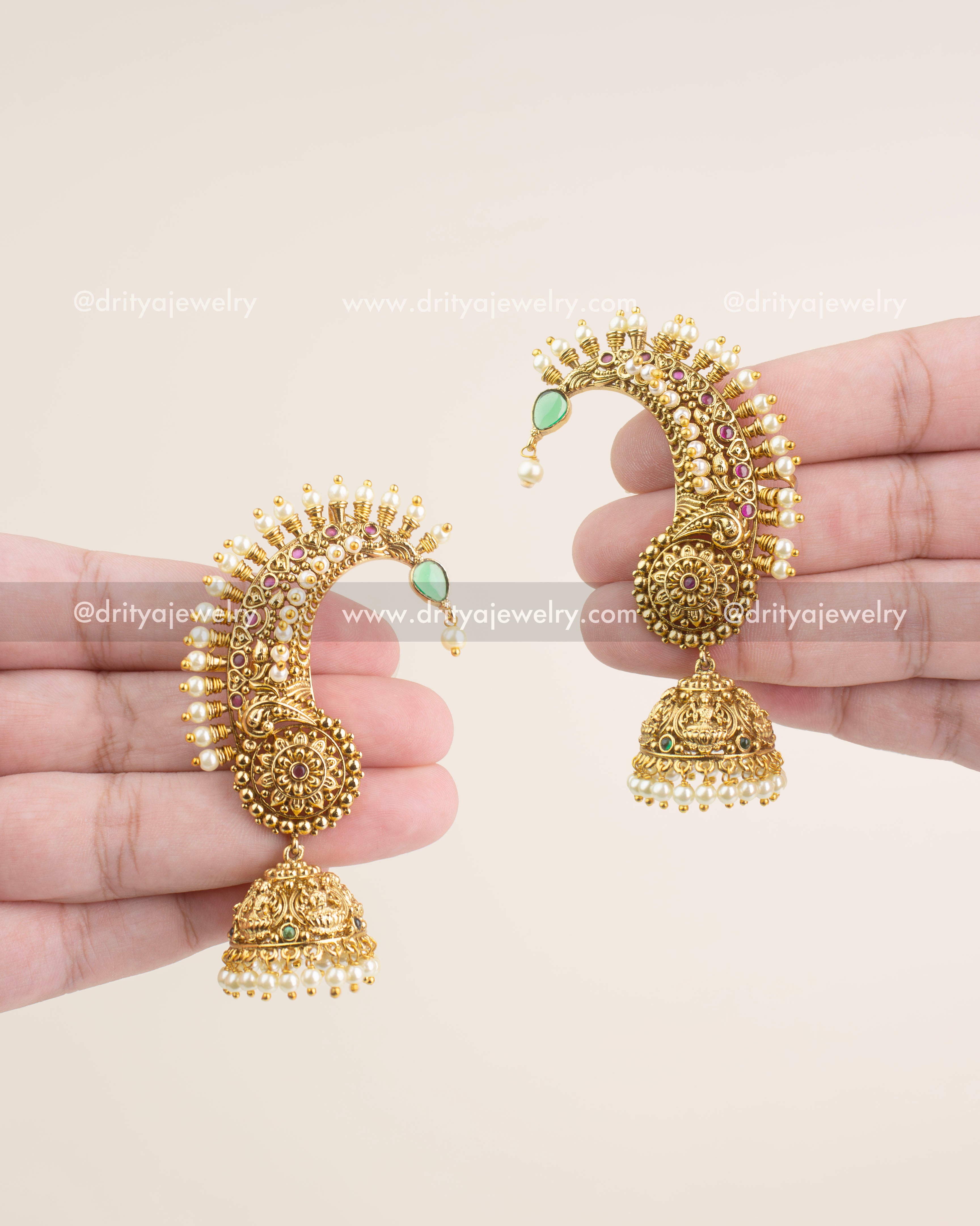 Antique gold temple ear cuffs with ruby accents, pearl borders, and Lakshmi-engraved jhumka drops.