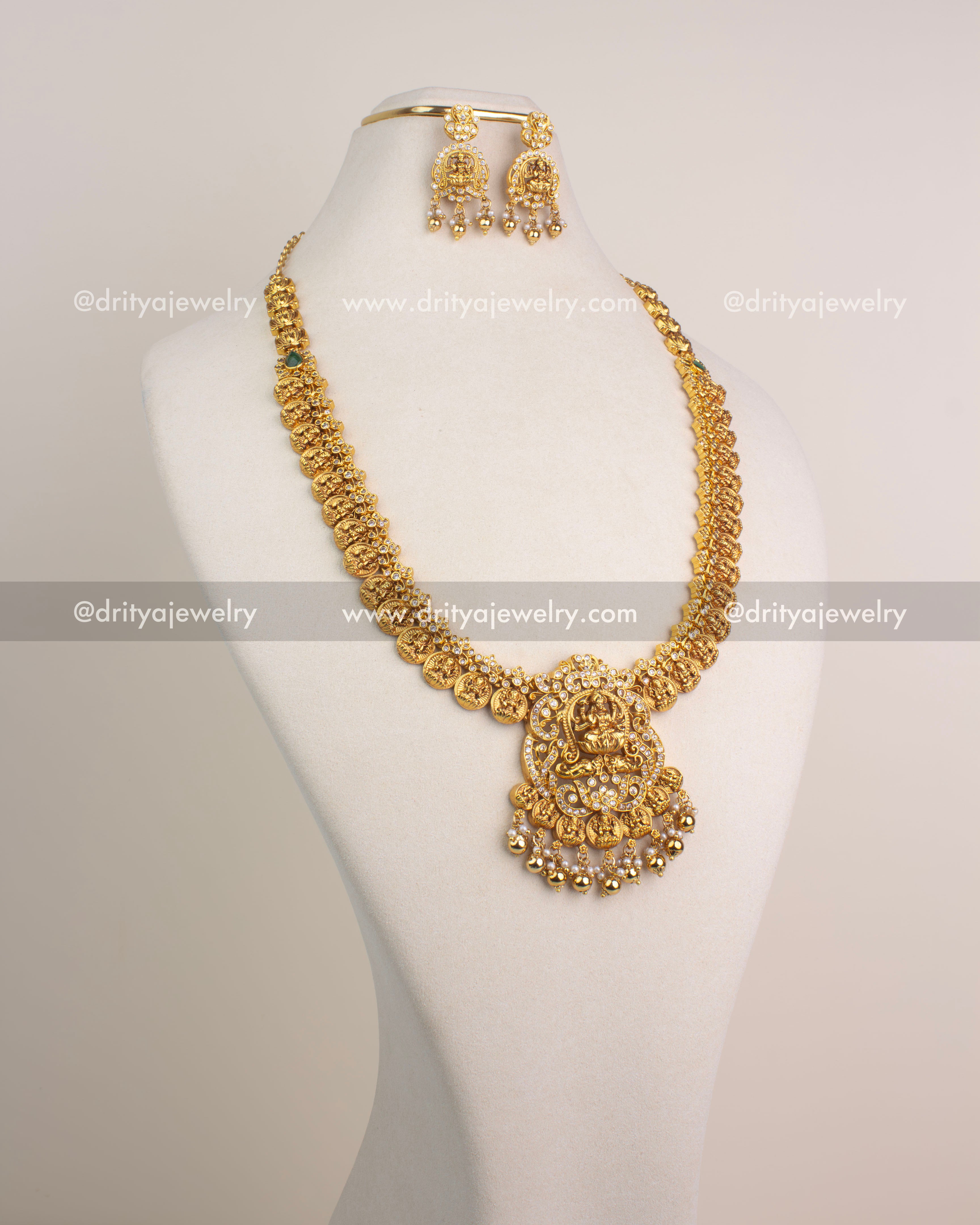 Traditional temple long haram with Lakshmi Devi pendant and Kasulu coin chain detailing in gold finish.
