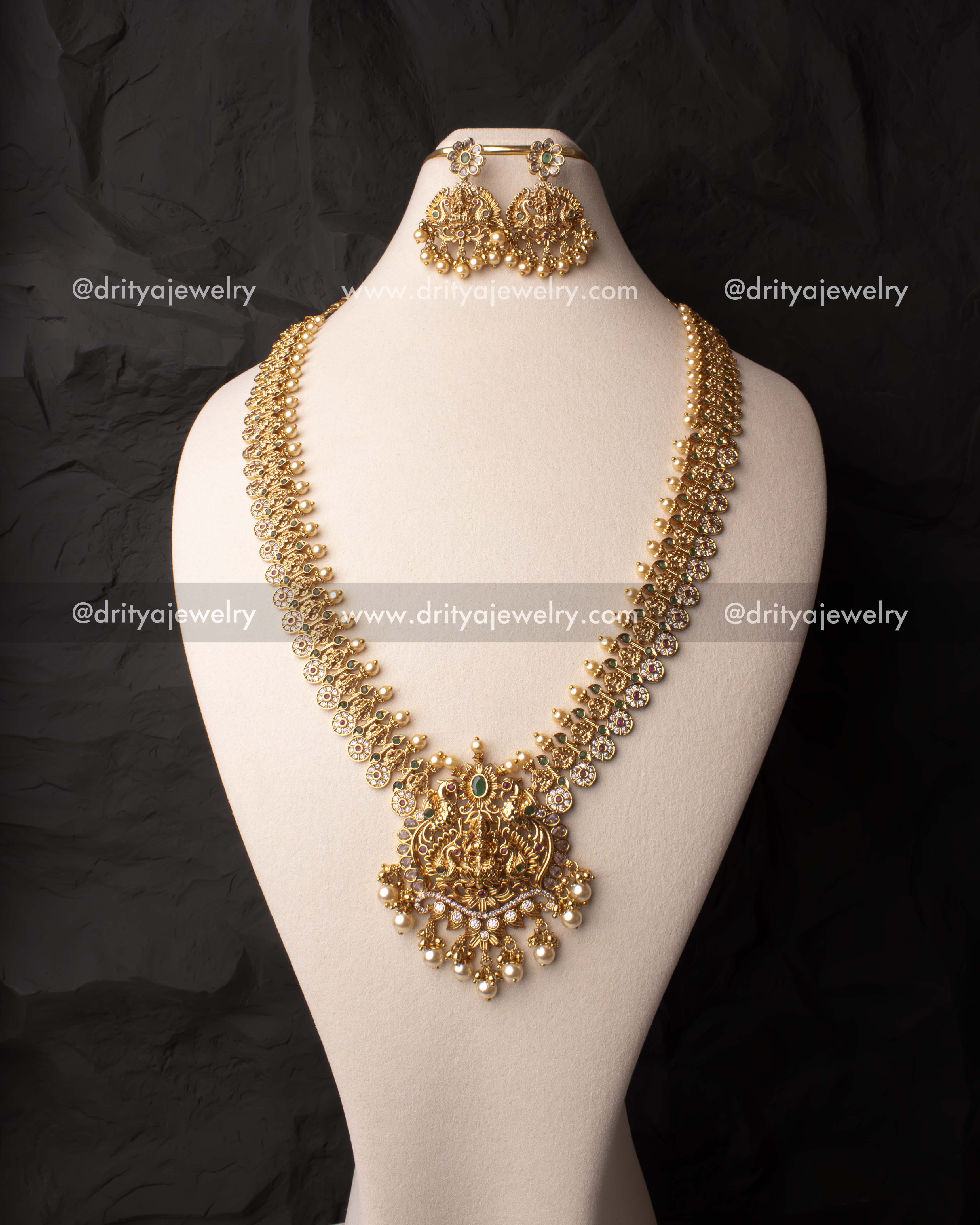 Gold-plated temple long necklace featuring a goddess motif pendant with pearl drops.