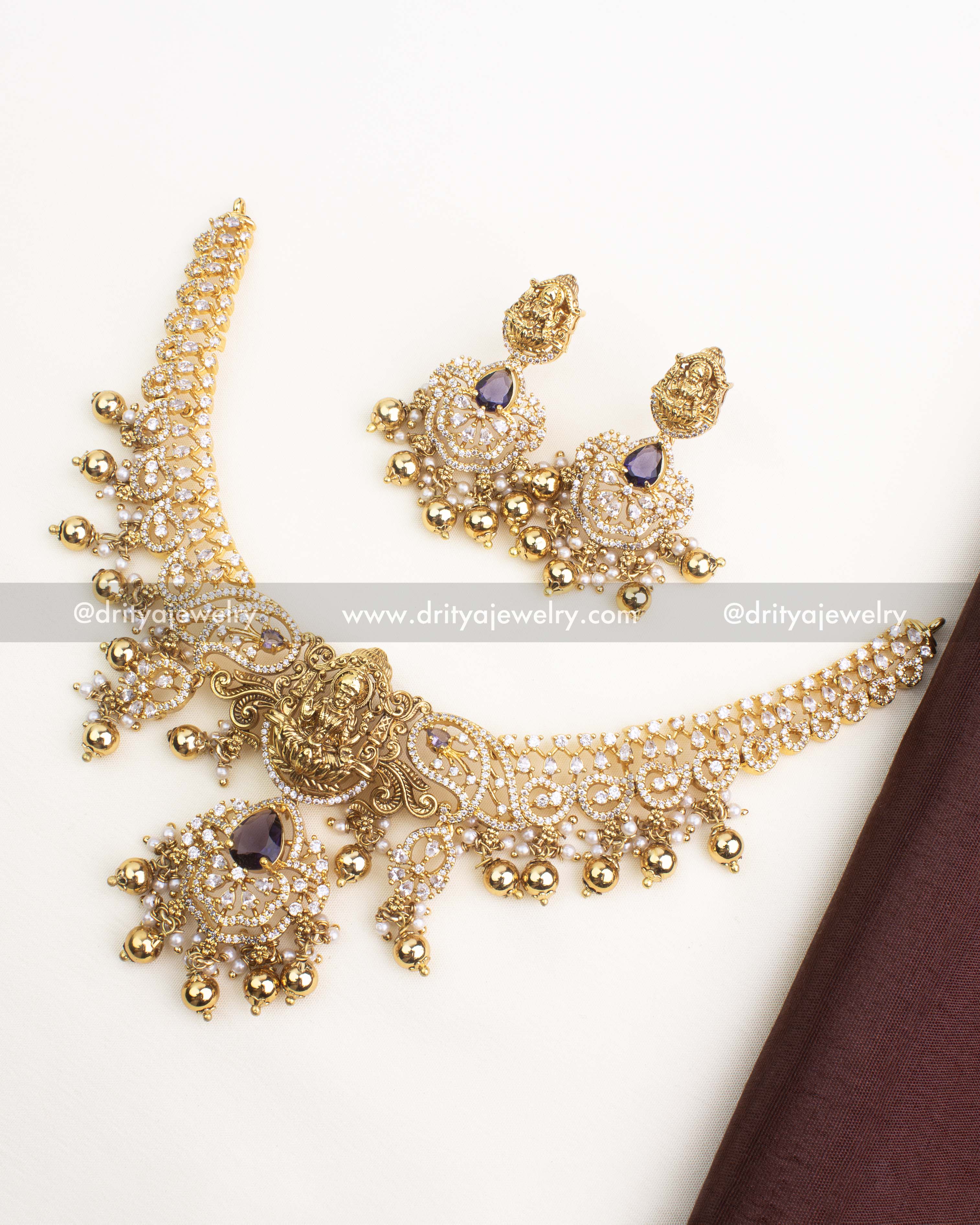 Antique gold temple short necklace with CZ stones, Lakshmi pendant, and purple stone drops.