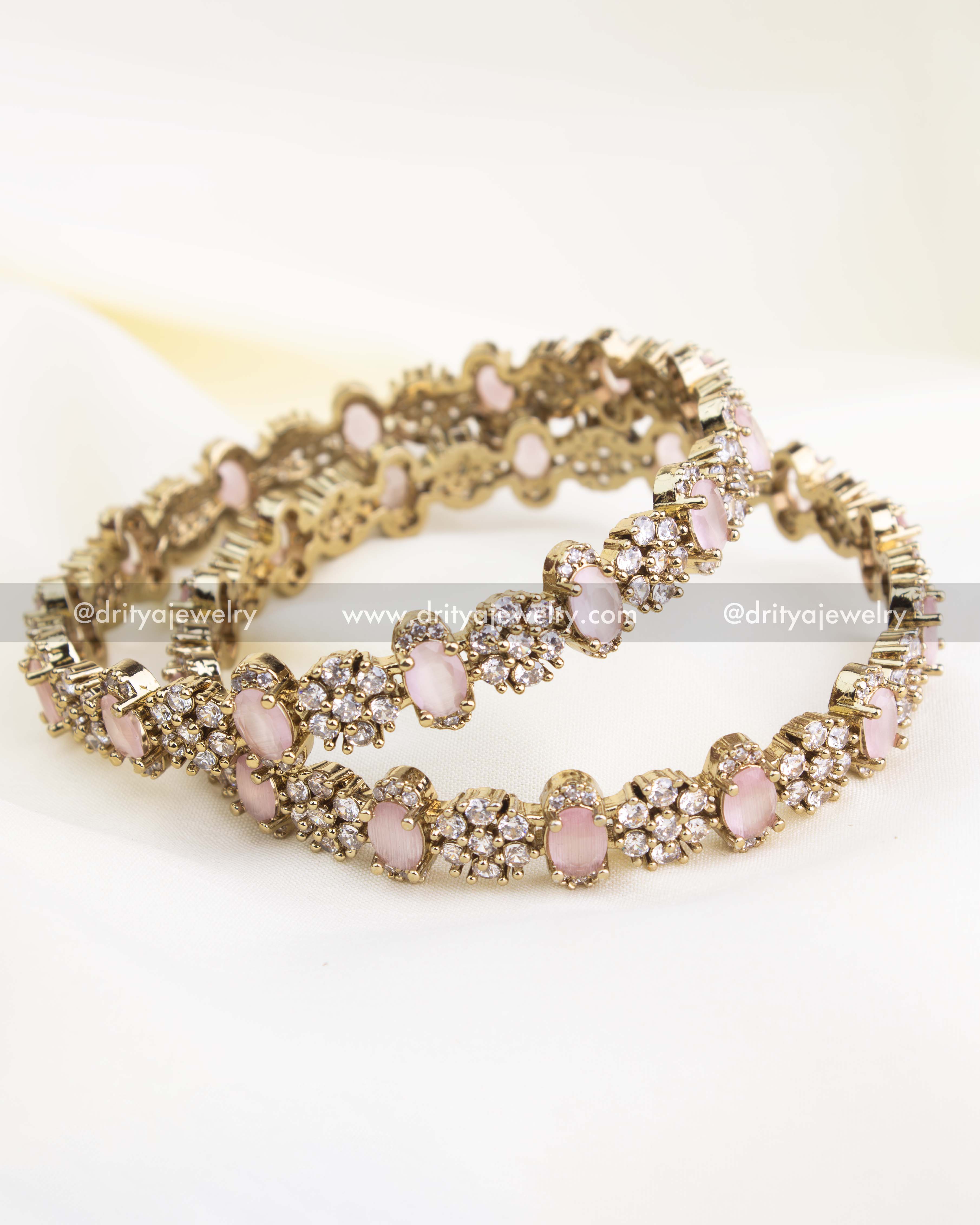 Antique gold Victorian bangles with blush pink oval stones and CZ cluster detailing.
