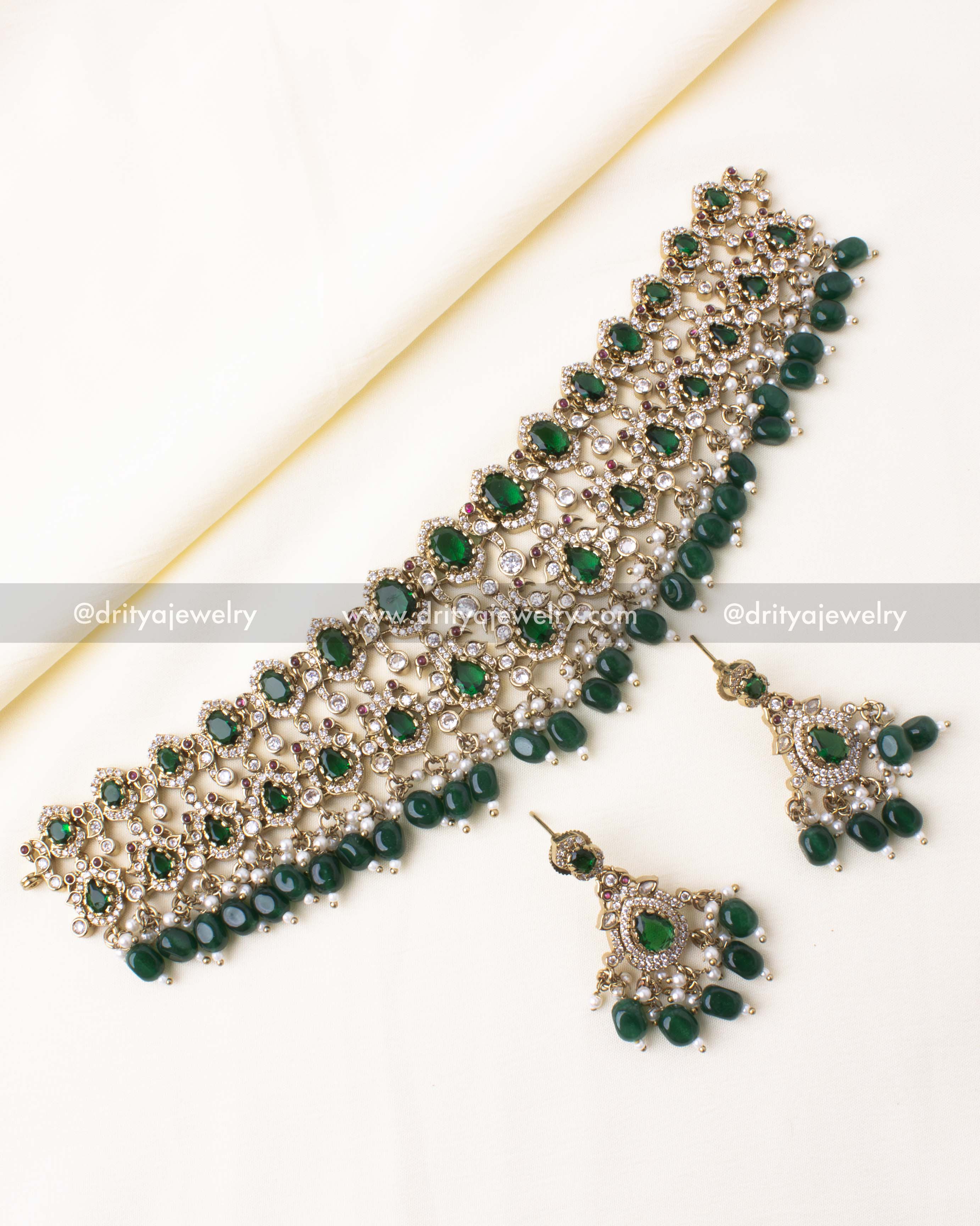 Elegant Victorian choker set with green gemstones, pearls, and gold-tone detailing.