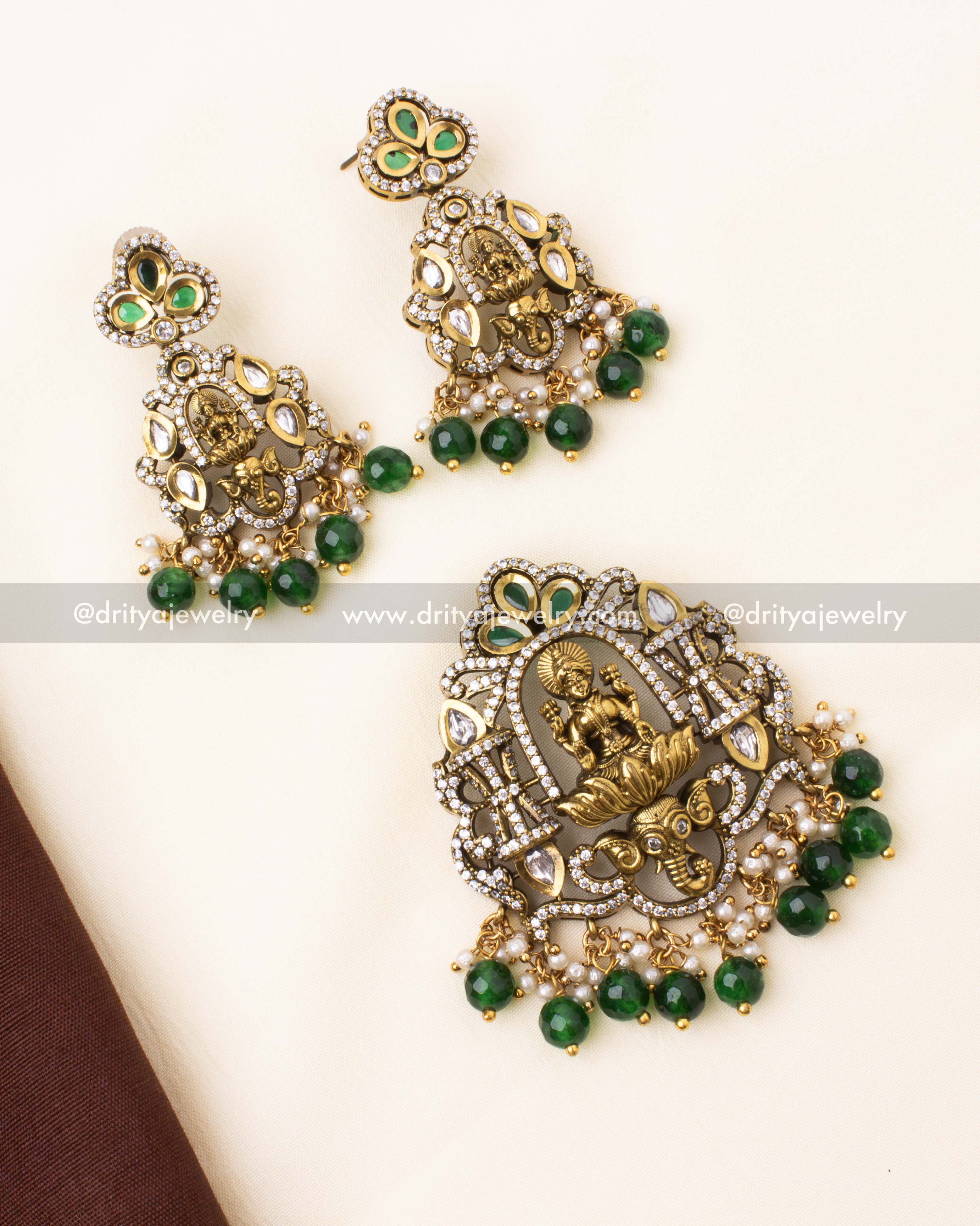 Elegant Victorian pendant set featuring Goddess Lakshmi, polki stones, and emerald beads.
