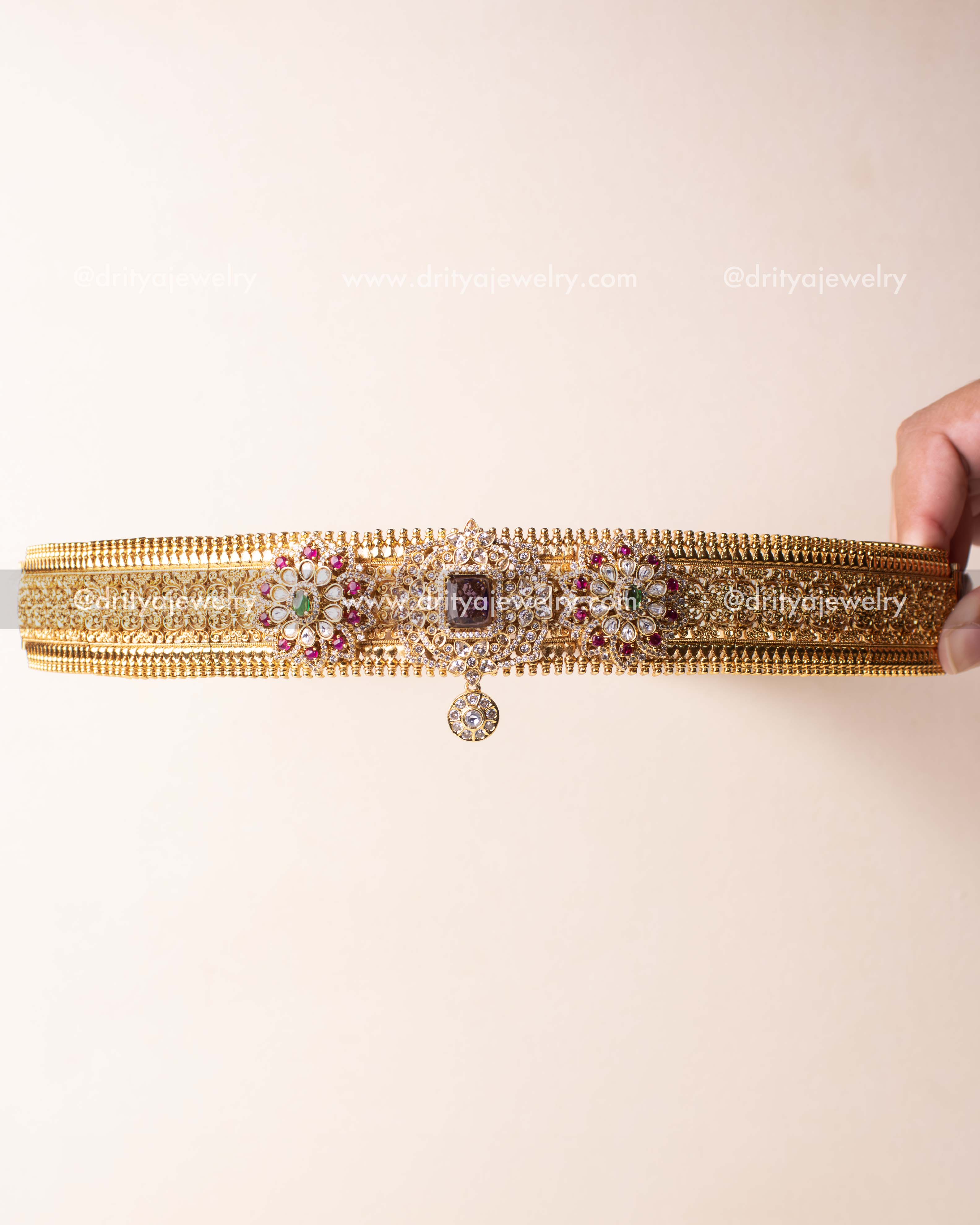 Minimal design waist belt featuring floral Kundan work and square AD stone centerpiece in antique gold finish.