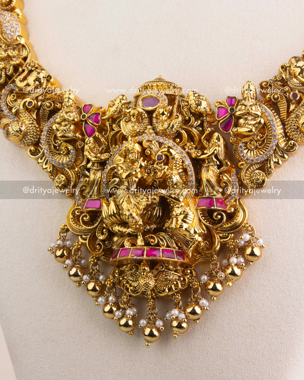 Premium kemp stone-studded Radha Krishna pendant with gold bead and pearl drops.