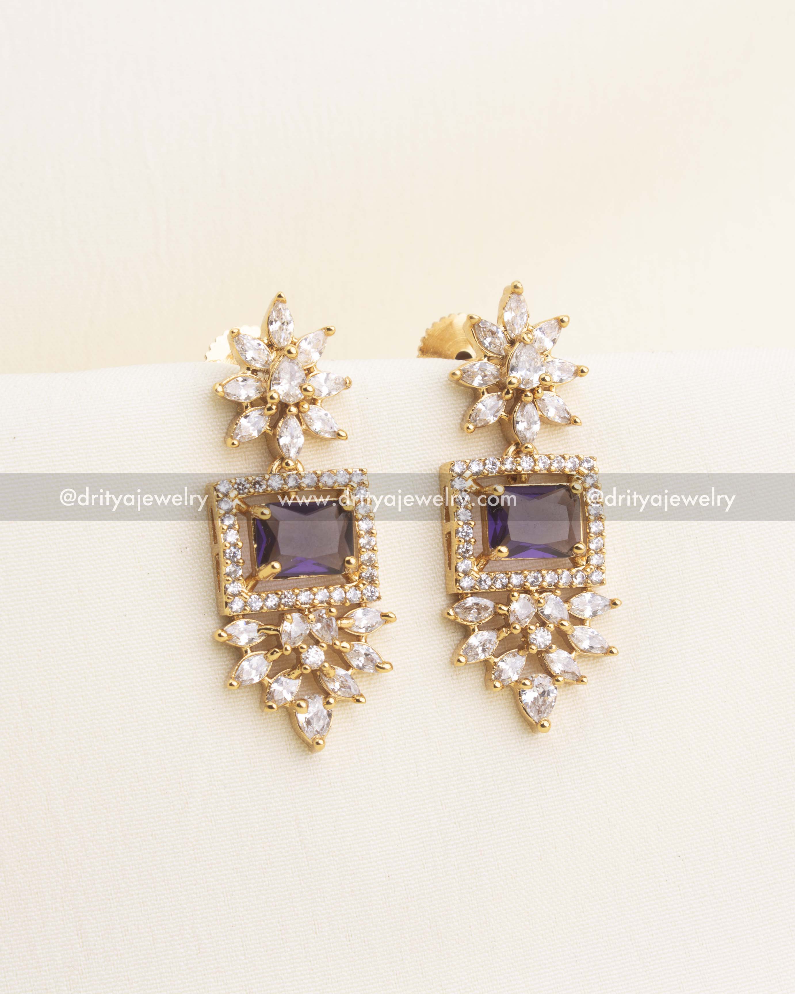 Earrings featuring purple square stone and delicate CZ floral clusters.