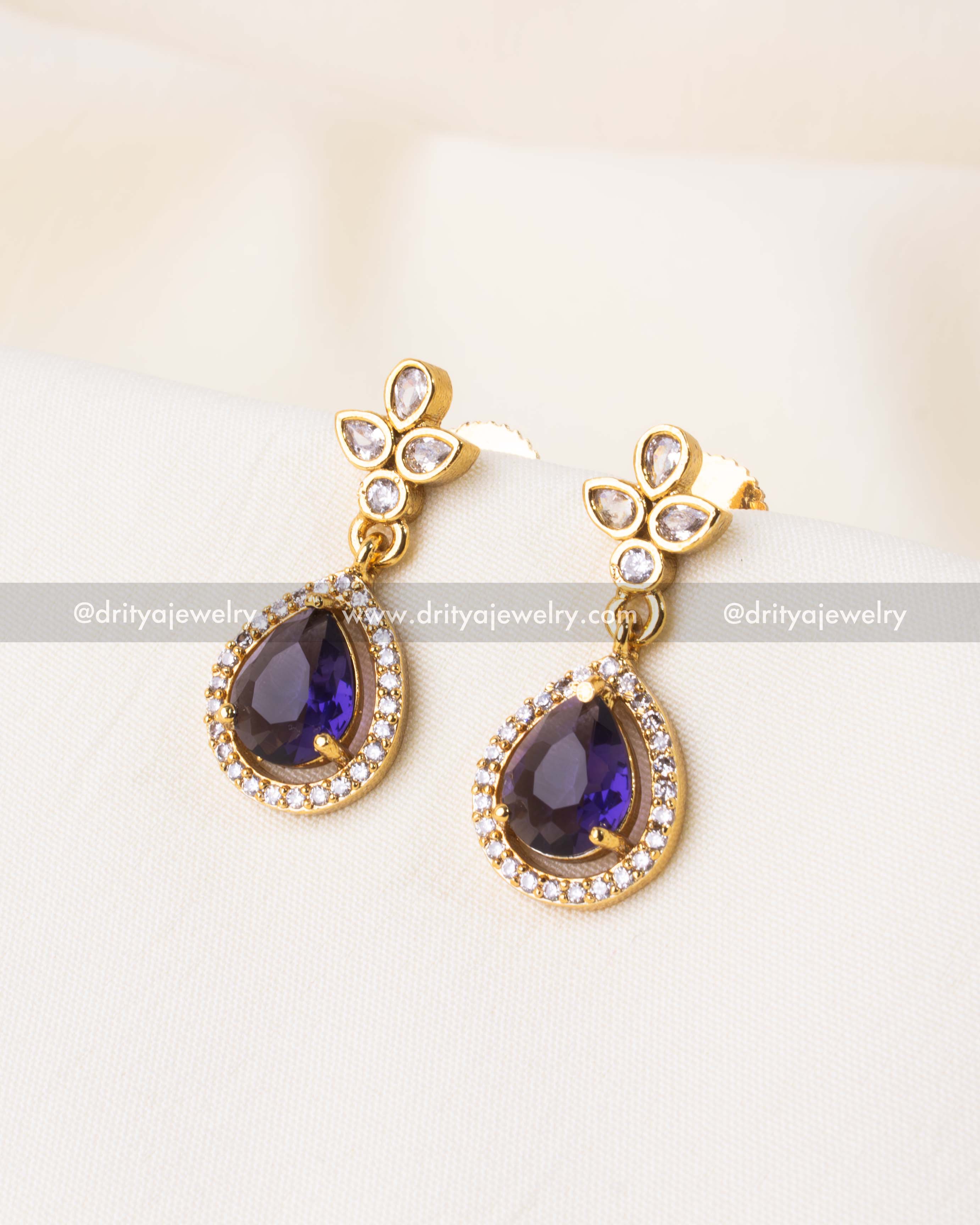 Matching purple earrings with gold finish and CZ floral tops.