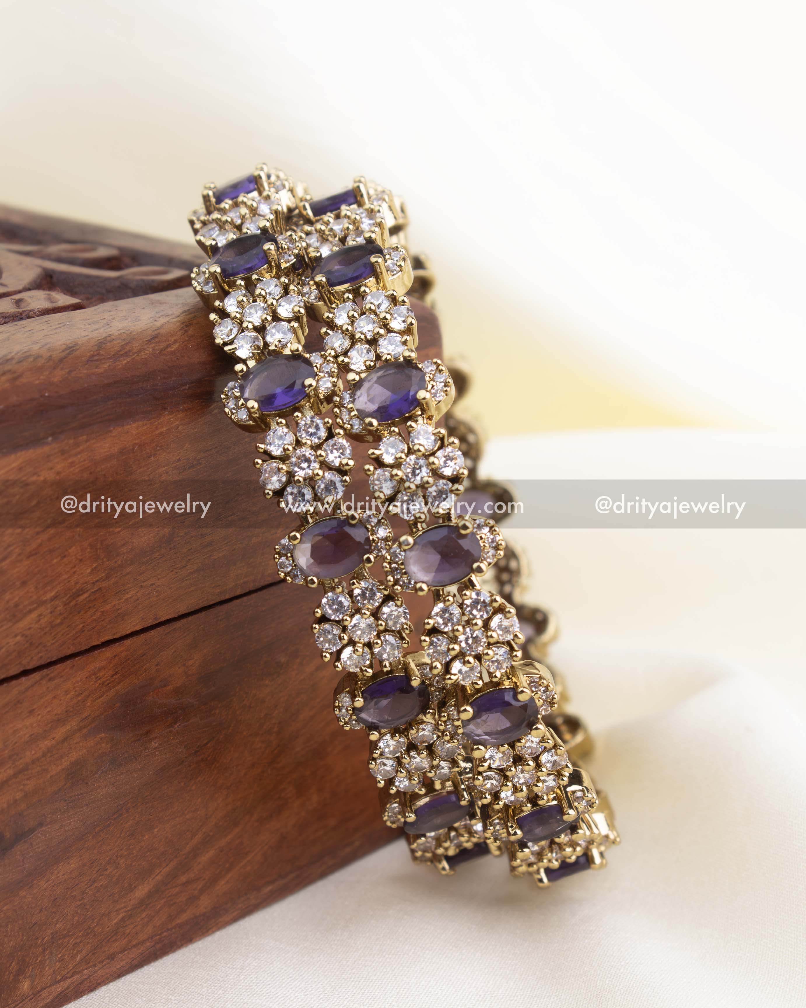 Antique gold Victorian bangle set with purple stones and white CZ detailing.