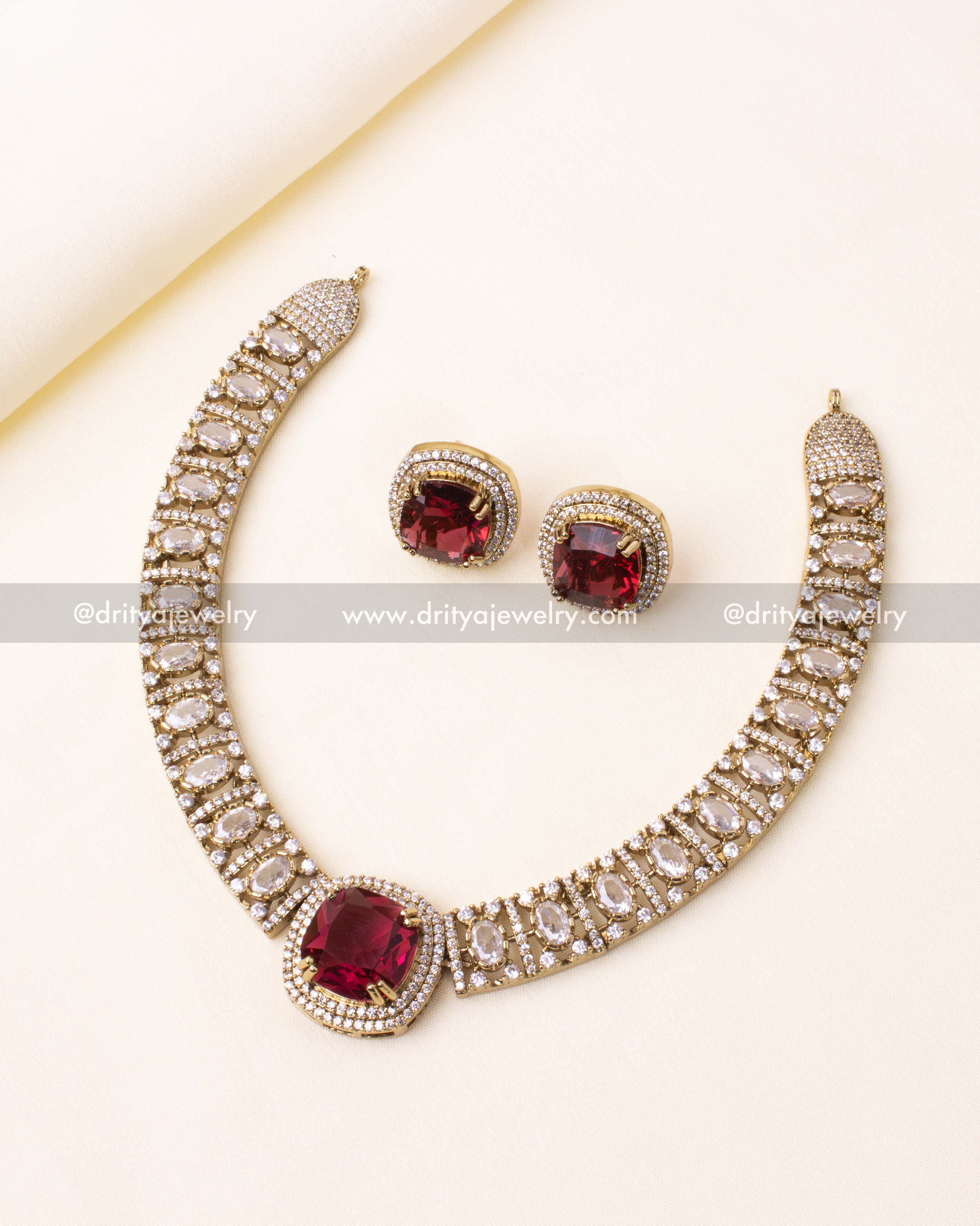 Gold-plated AD short necklace set featuring a striking red gemstone centerpiece, paired with matching earrings.