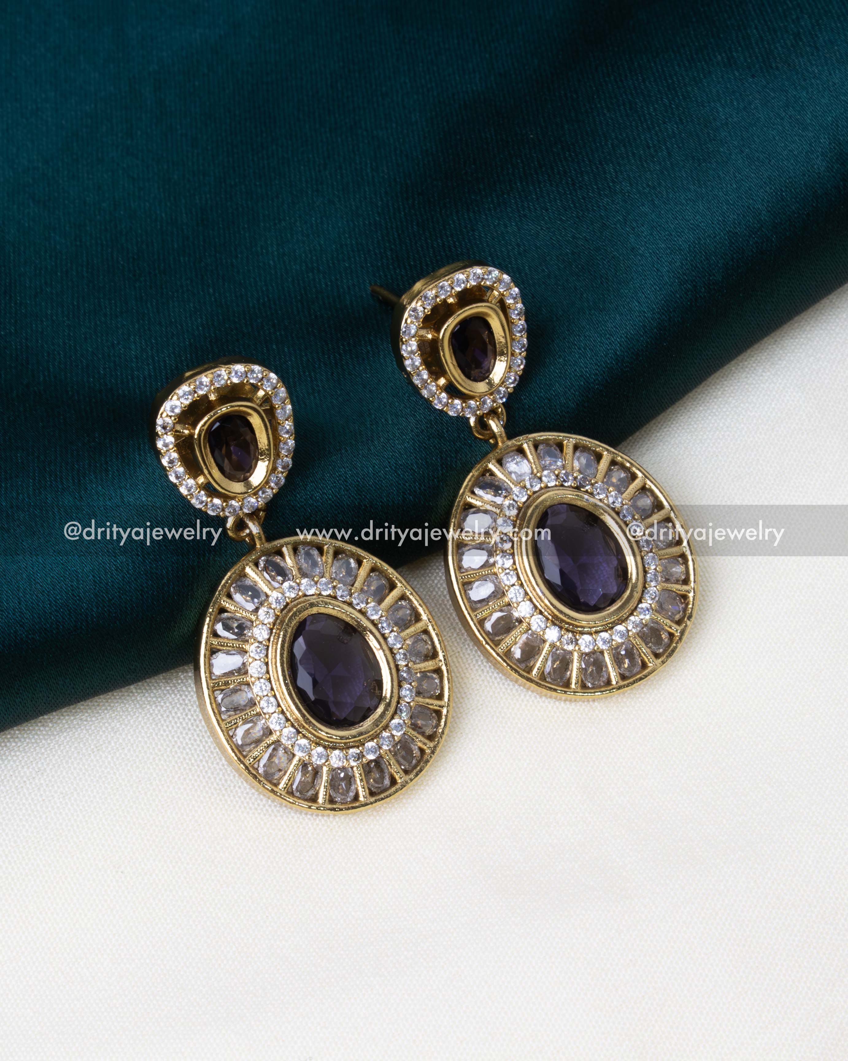 Drop earrings with deep purple stones and a polished gold finish.