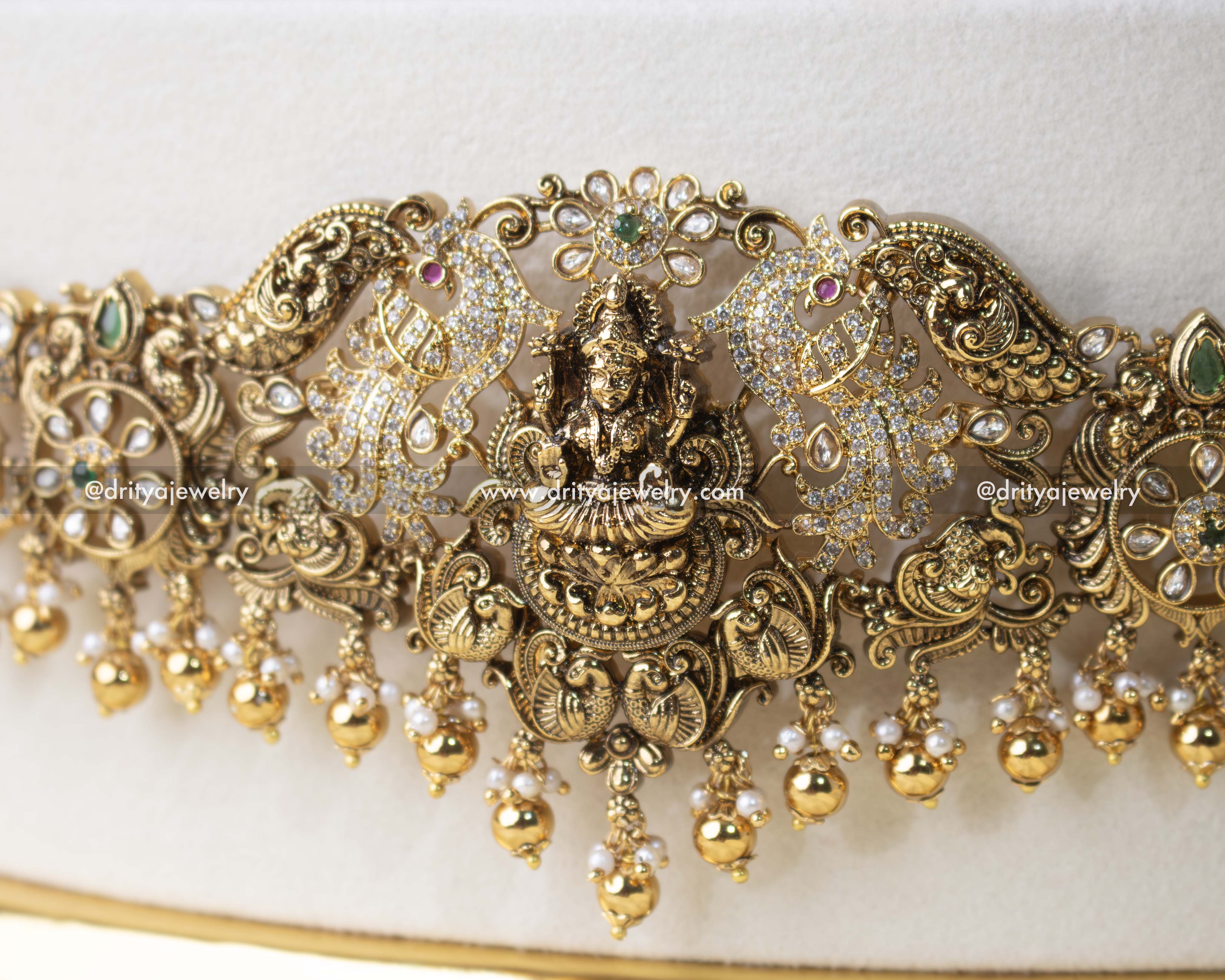 Detailed view of waist belt with intricate Nakshi motifs and pearl embellishments.