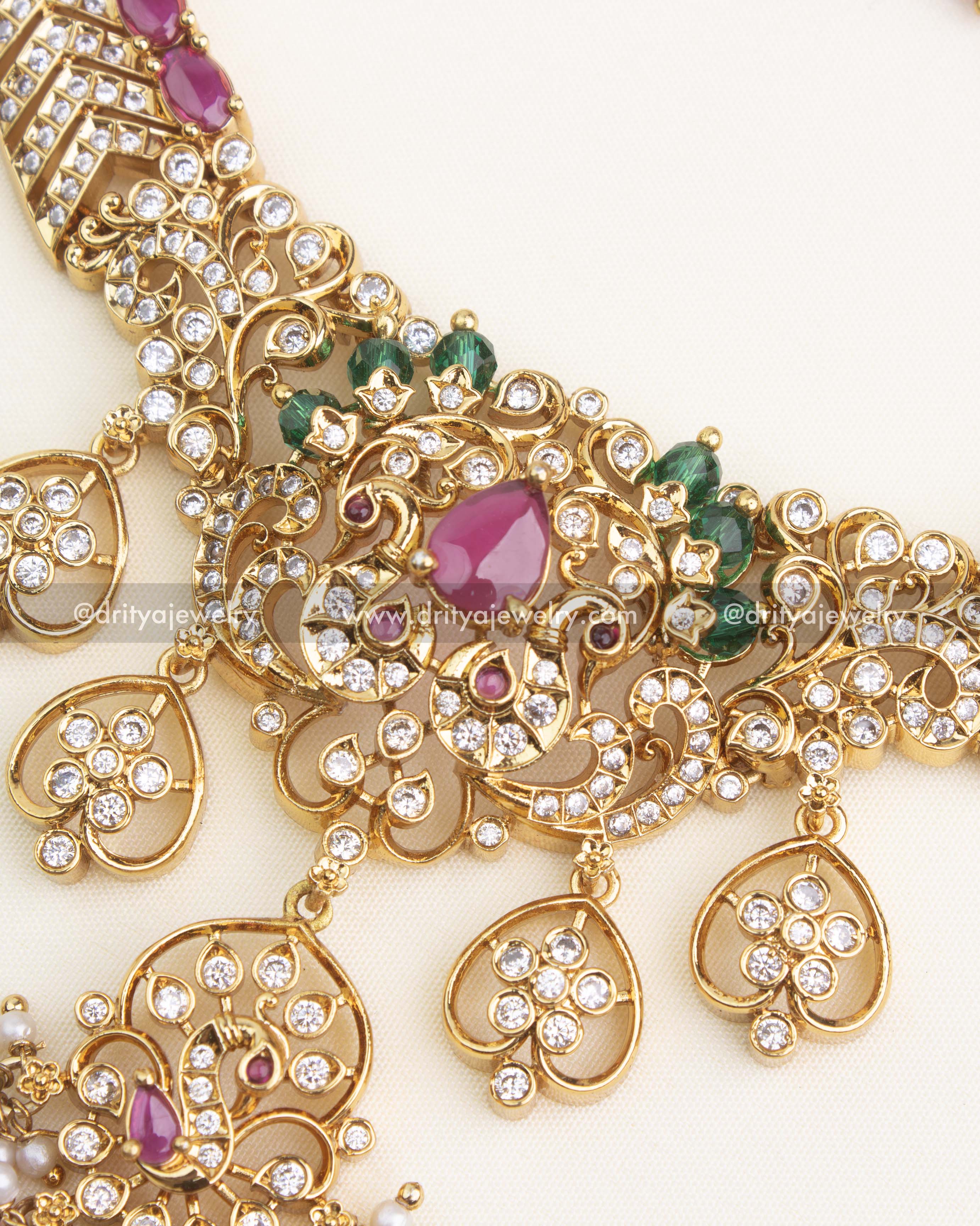 Close-up of premium ruby necklace featuring pink teardrop beads, green stone accents, and detailed AD floral motifs.