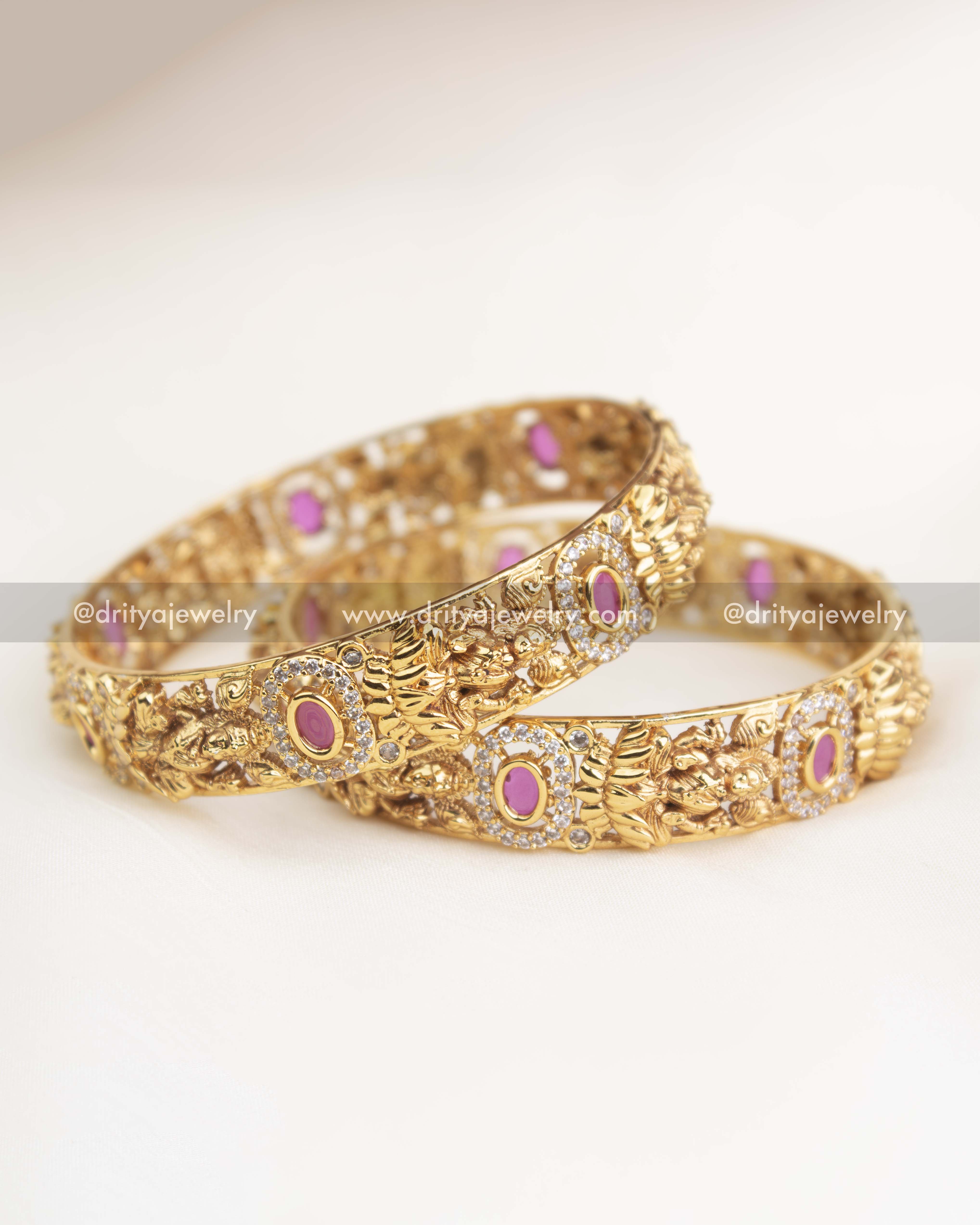 Close-up showing ruby pink centerpiece, halo of AD stones, and intricate temple goddess artwork