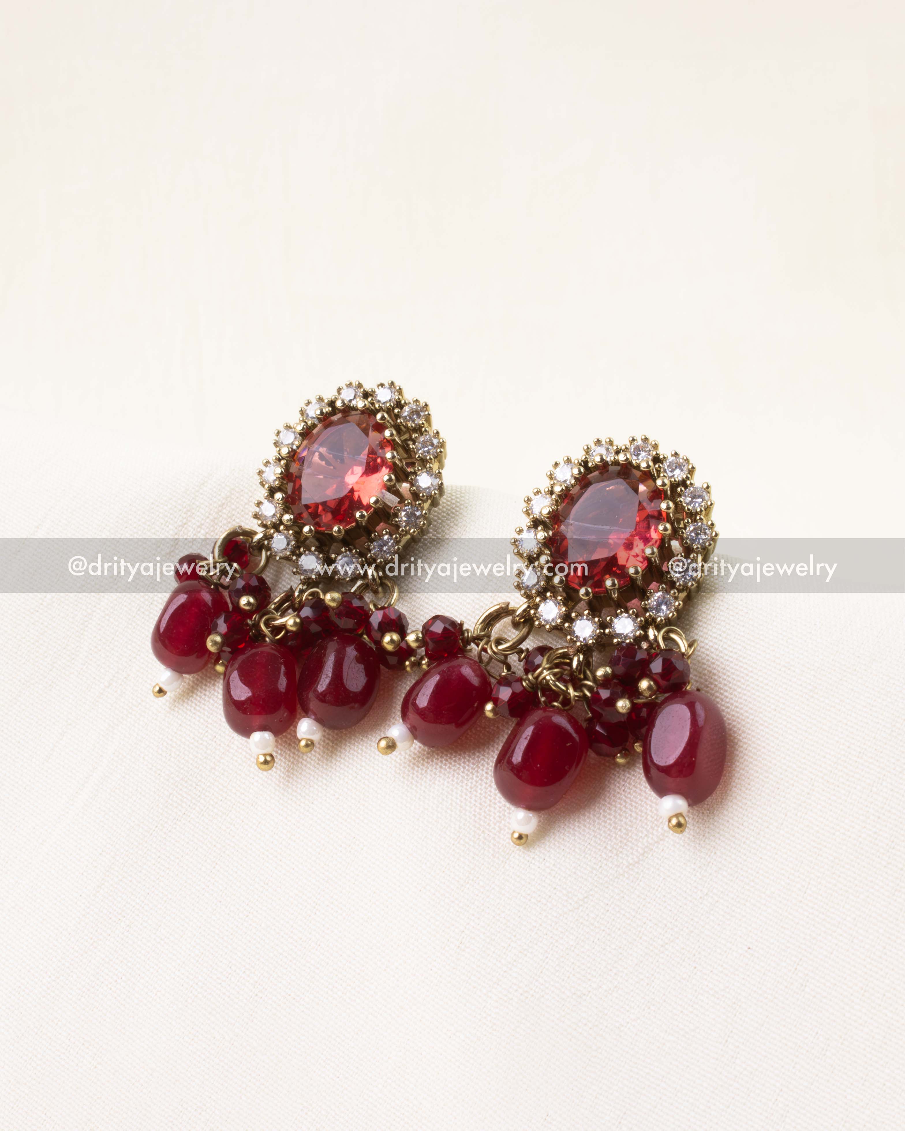 Matching earrings with red center stones and bead tassels