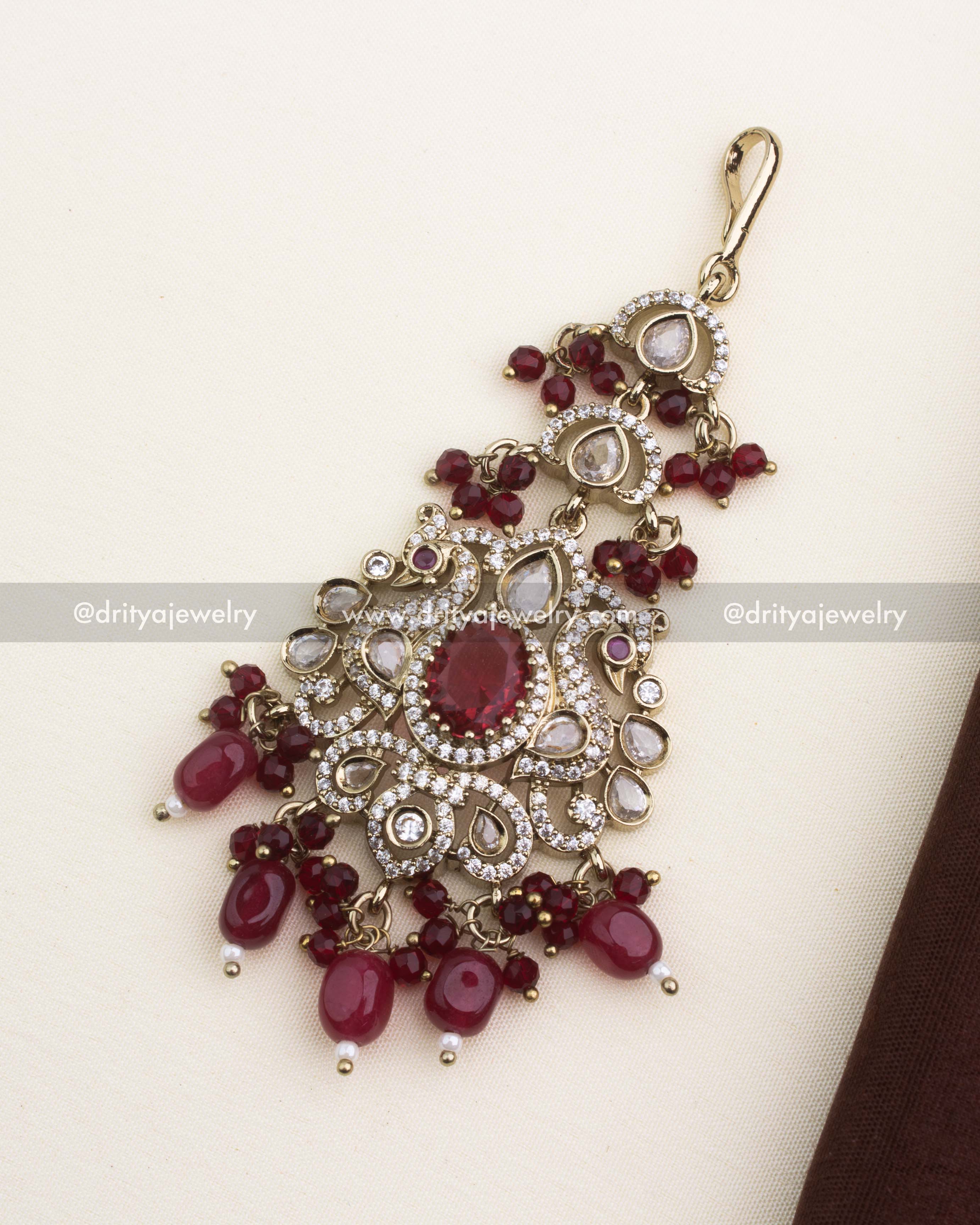 Bridal Victorian maang tikka with ruby red center stone, kundan detailing, and red bead hangings